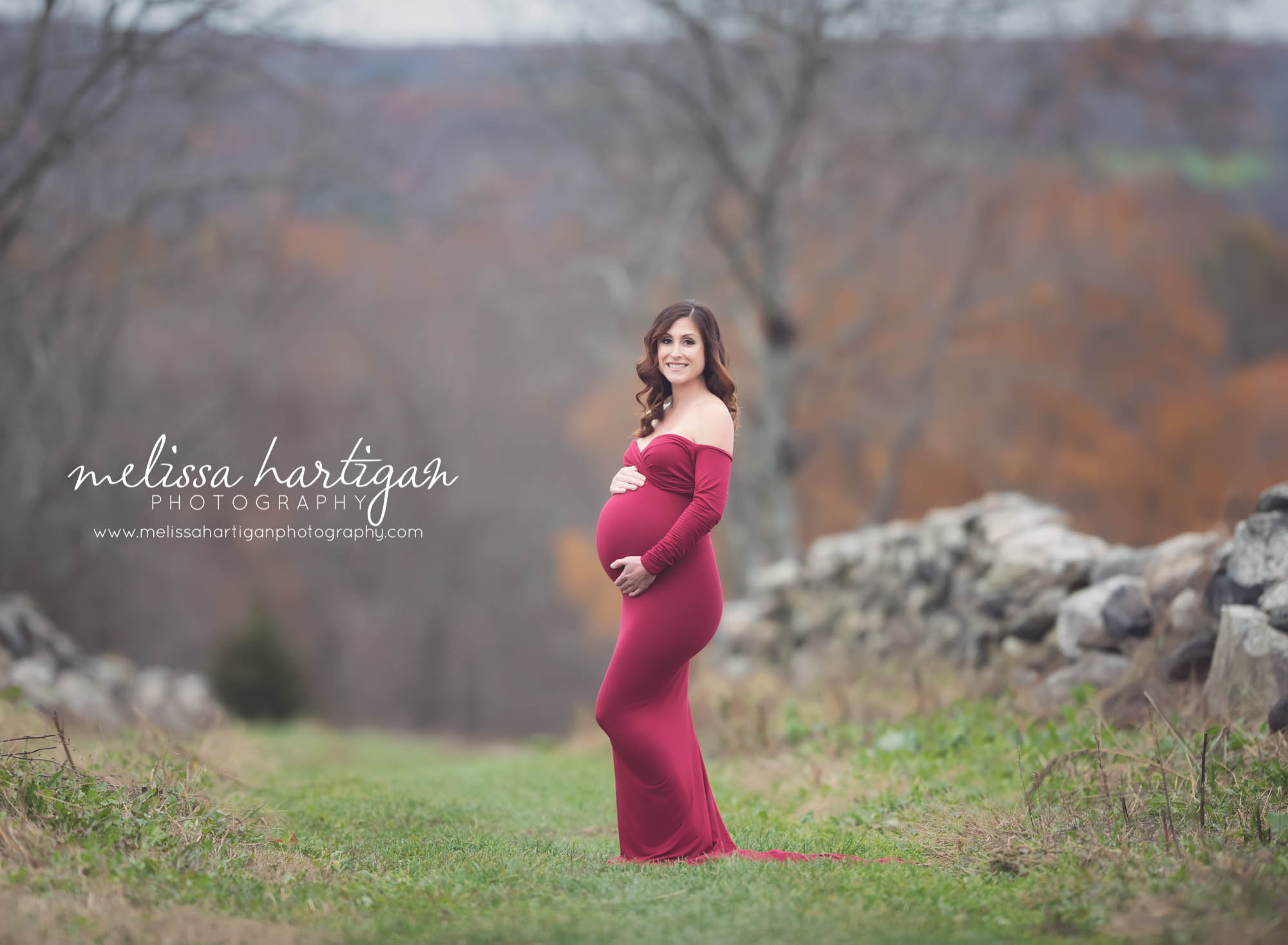 Melissa Hartigan Photography Coventry CT Newborn & Maternity Photographer Coventry CT Maternity Newborn Session Carrie wearing red maternity gown standing in field