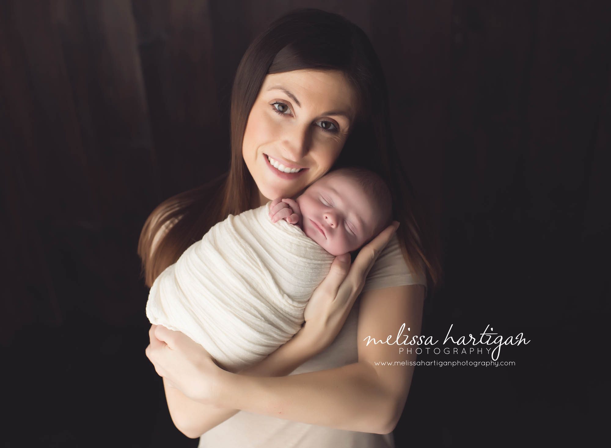 Melissa Hartigan Photography Coventry CT Newborn & Maternity Photographer Coventry CT Maternity Newborn Session Chase sleeping wrapped in cream held by mom