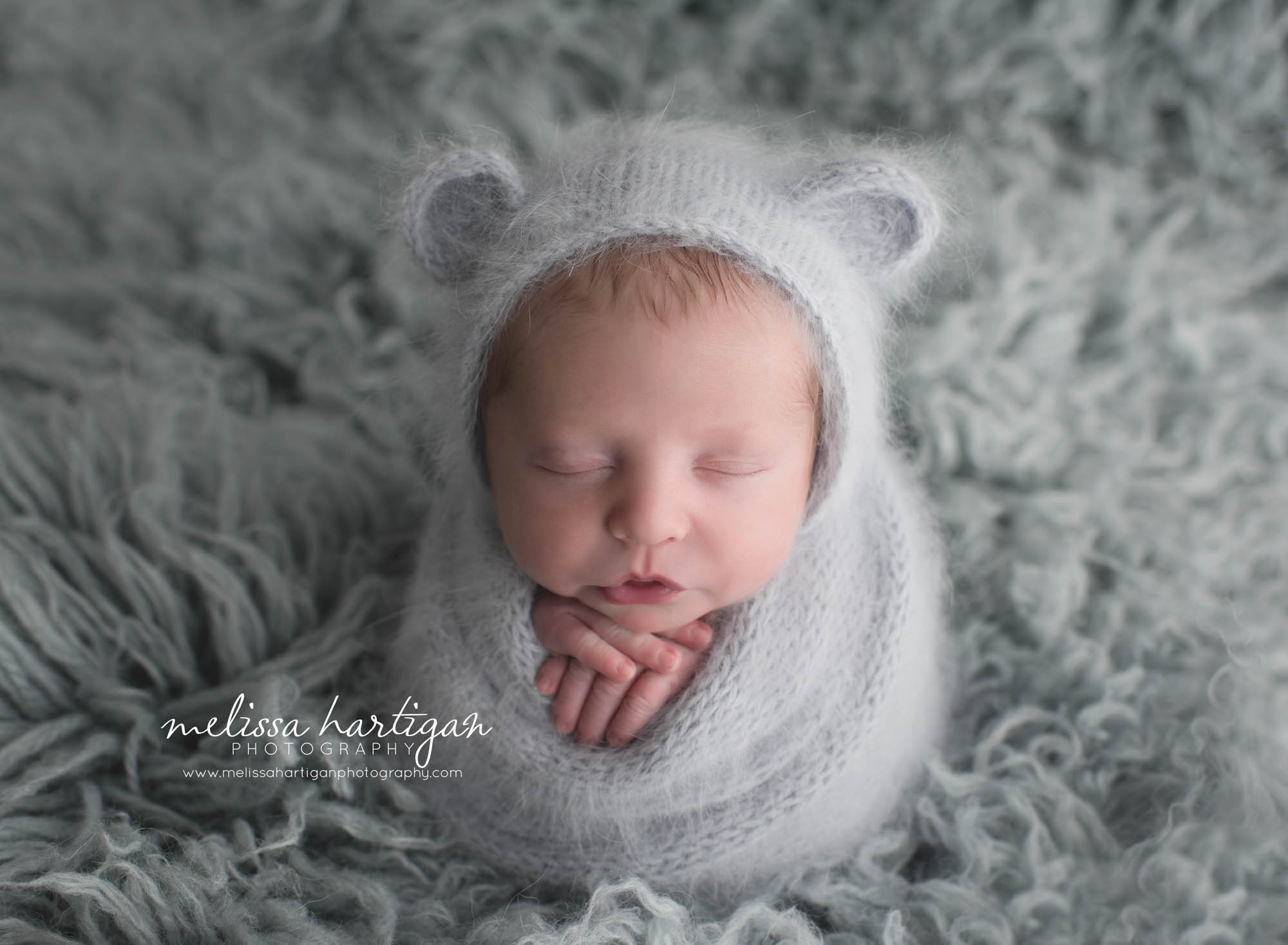 Melissa Hartigan Photography Coventry CT Newborn & Maternity Photographer Coventry CT Maternity Newborn Session Chase in gray wrap sleeping with bear ears knit hat