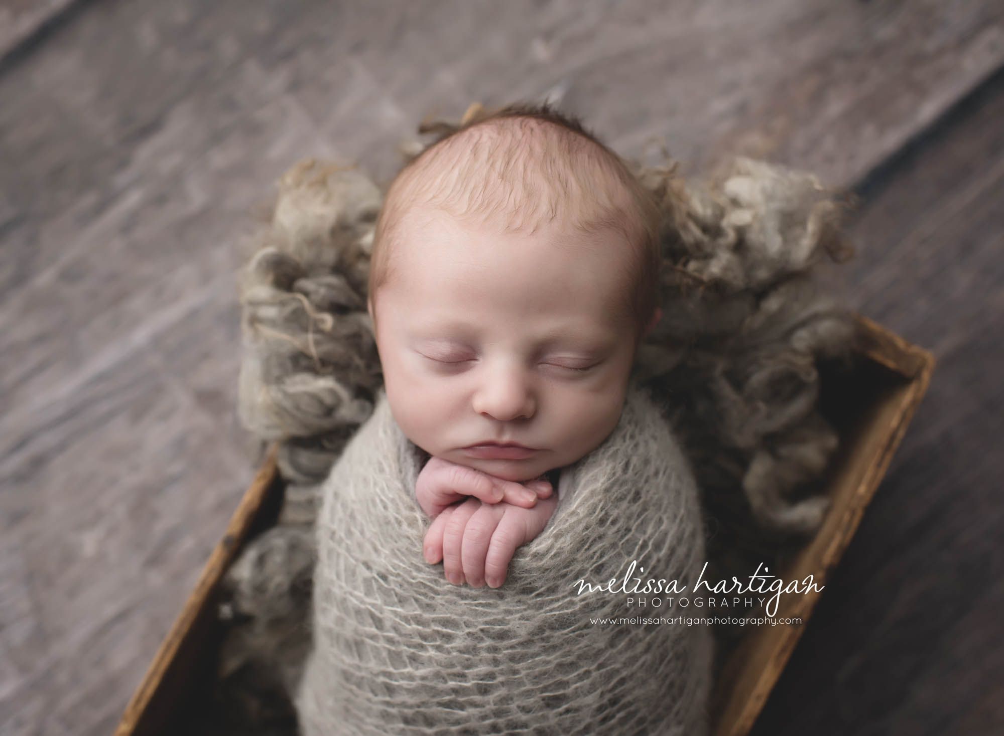 Melissa Hartigan Photography Coventry CT Newborn & Maternity Photographer Coventry CT Maternity Newborn Session Chase sleeping in wooden box wrapped in gray with hands out