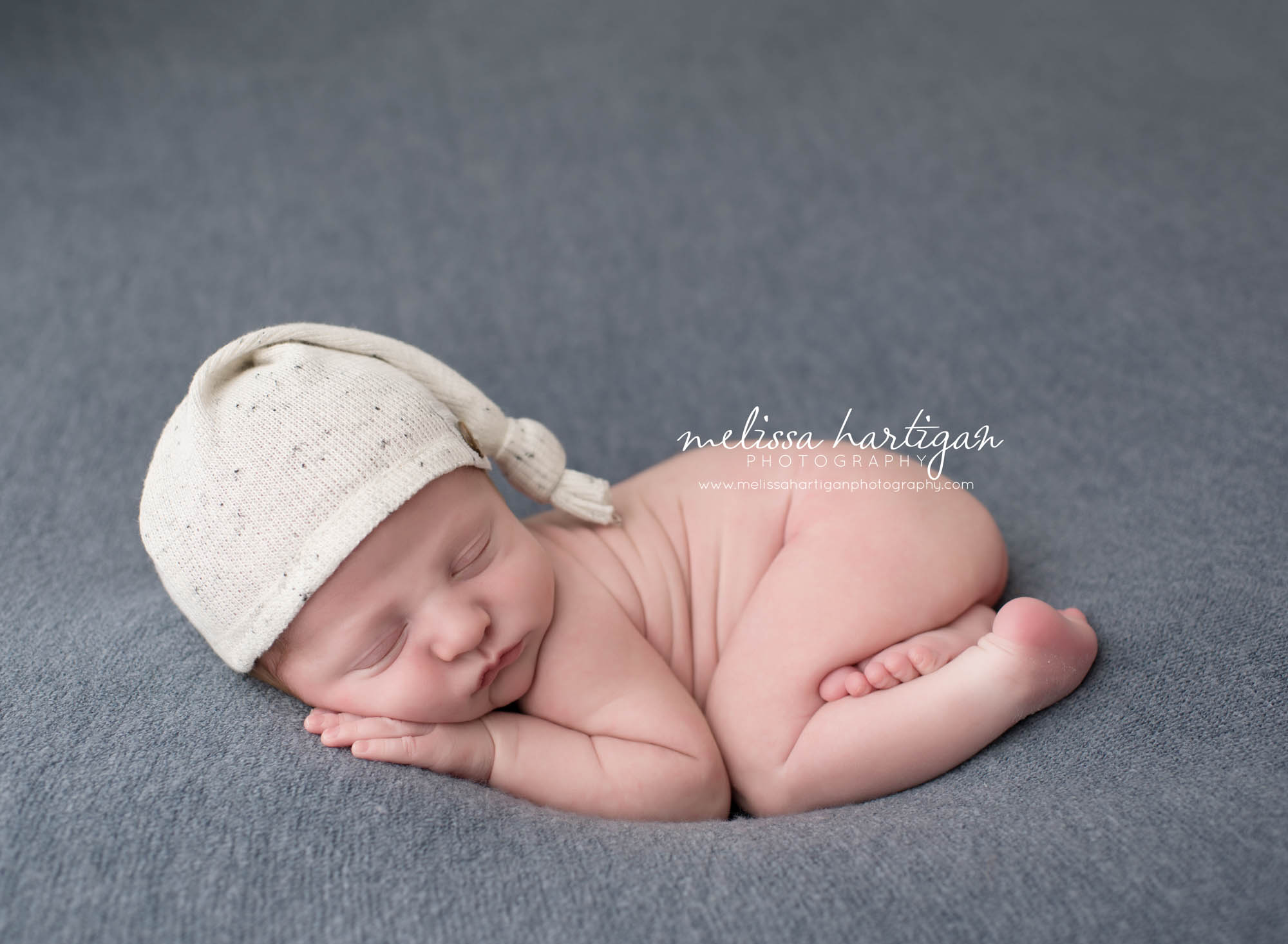 Melissa Hartigan Photography Coventry CT Newborn & Maternity Photographer Coventry CT Maternity Newborn Session Chase sleeping on blue blanket wearing cream knit hat