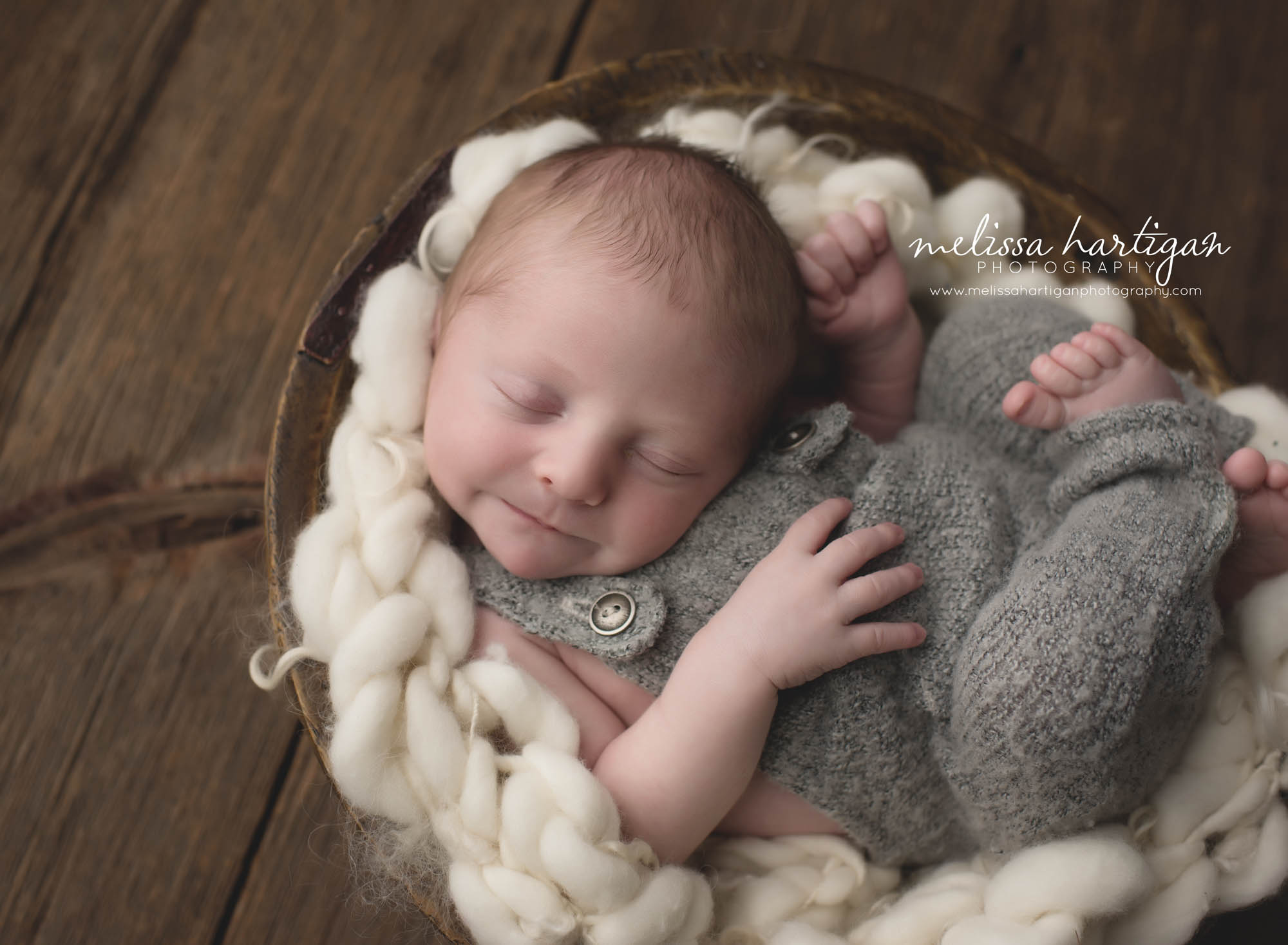 Melissa Hartigan Photography Coventry CT Newborn & Maternity Photographer Coventry CT Maternity Newborn Session Chase sleeping in wooden bowl with cream knit blanket wearing gray knit overalls