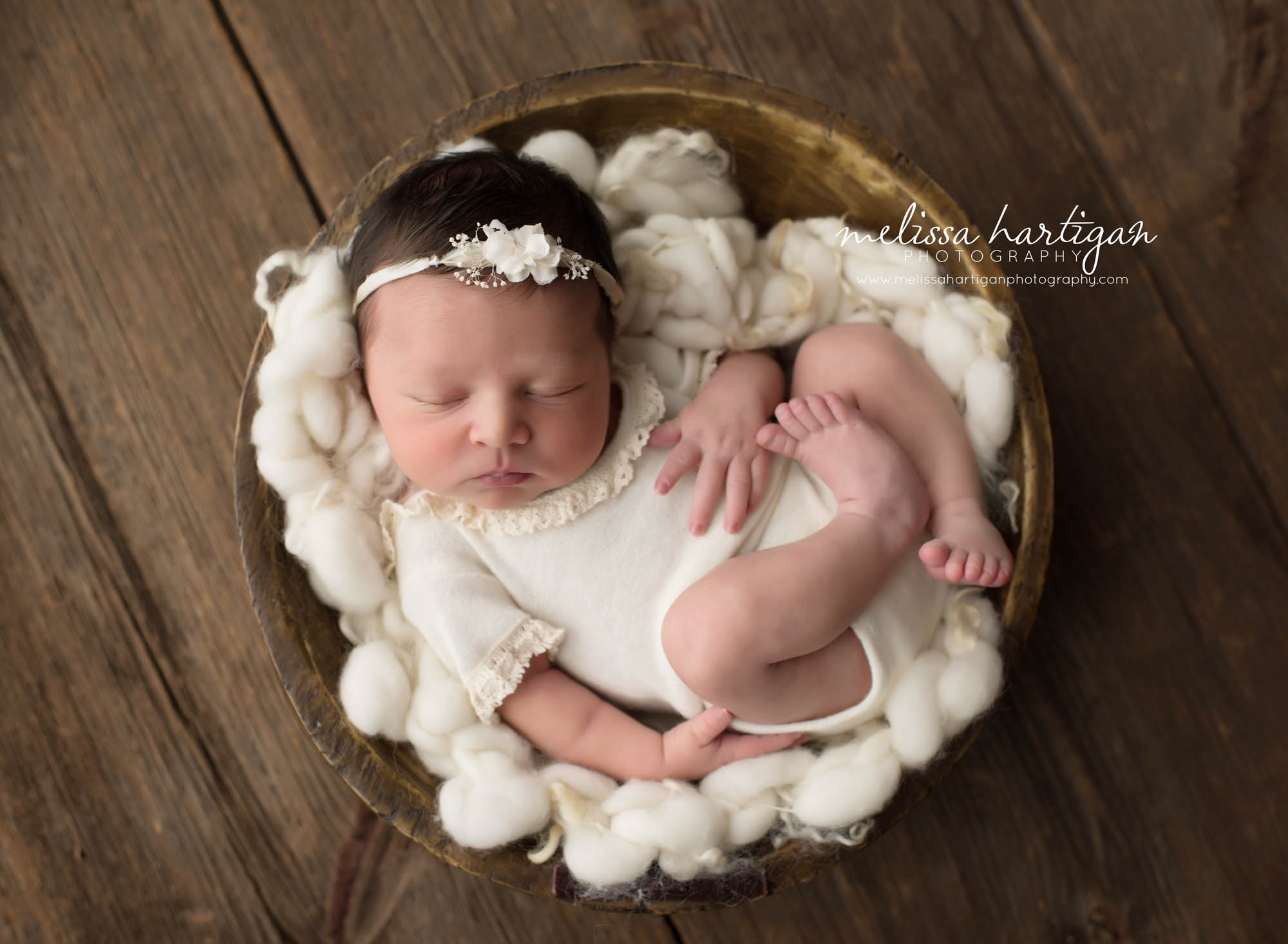 Melissa Hartigan Photography Connecticut Newborn Photographer trumbull Ct baby Fairfield county Baby girl white knit onesie and headband in wooden bowl sleeping CT mini newborn session