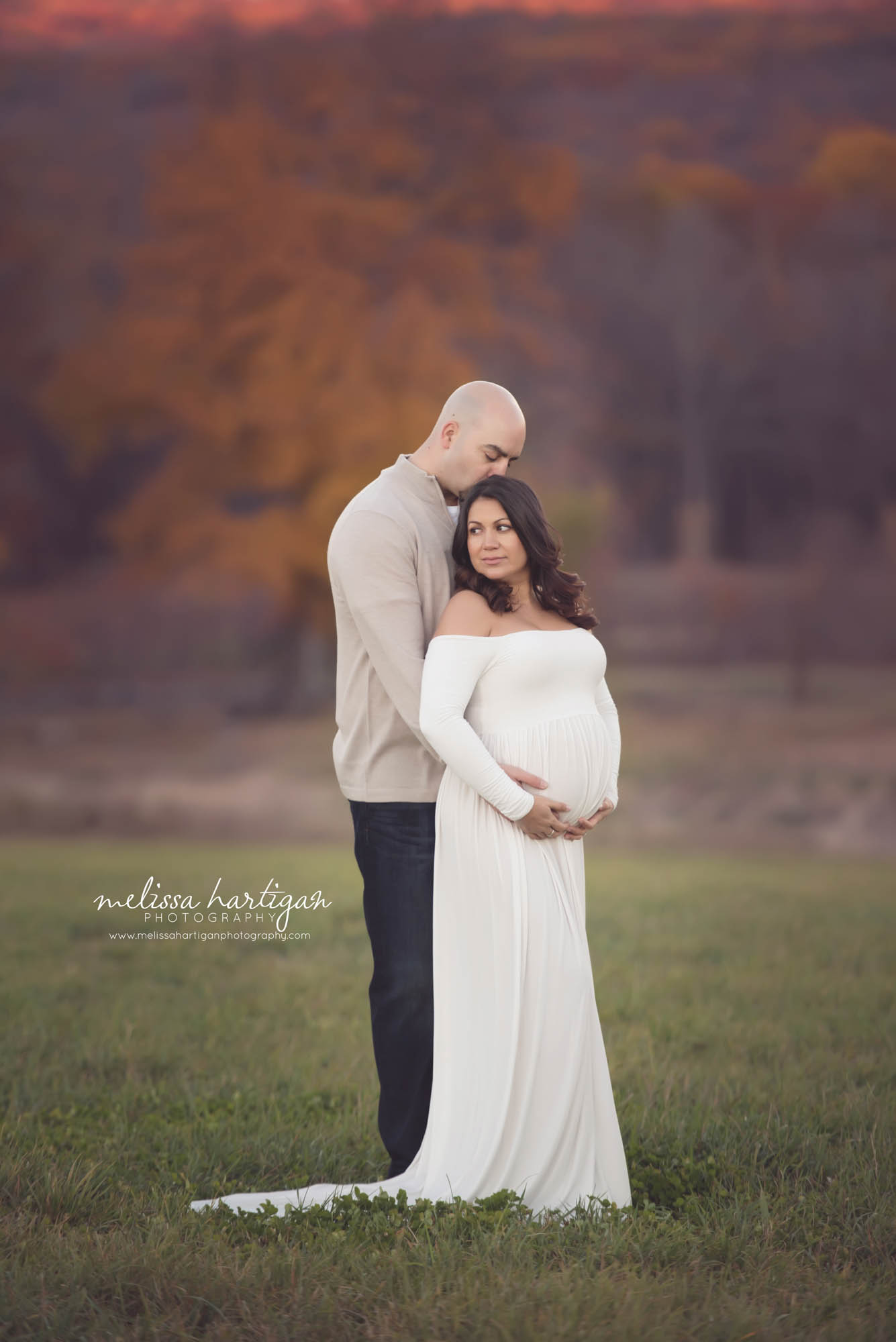 Melissa Hartigan Photography Connecticut Best Maternity Photographer in CT Coventry Ct Middlefield CT baby Fairfield county Newborn and maternity CT photographer Maternity photographer Parents-to-be outdoor session wearing white maternity dress husband standing behind holding belly in field