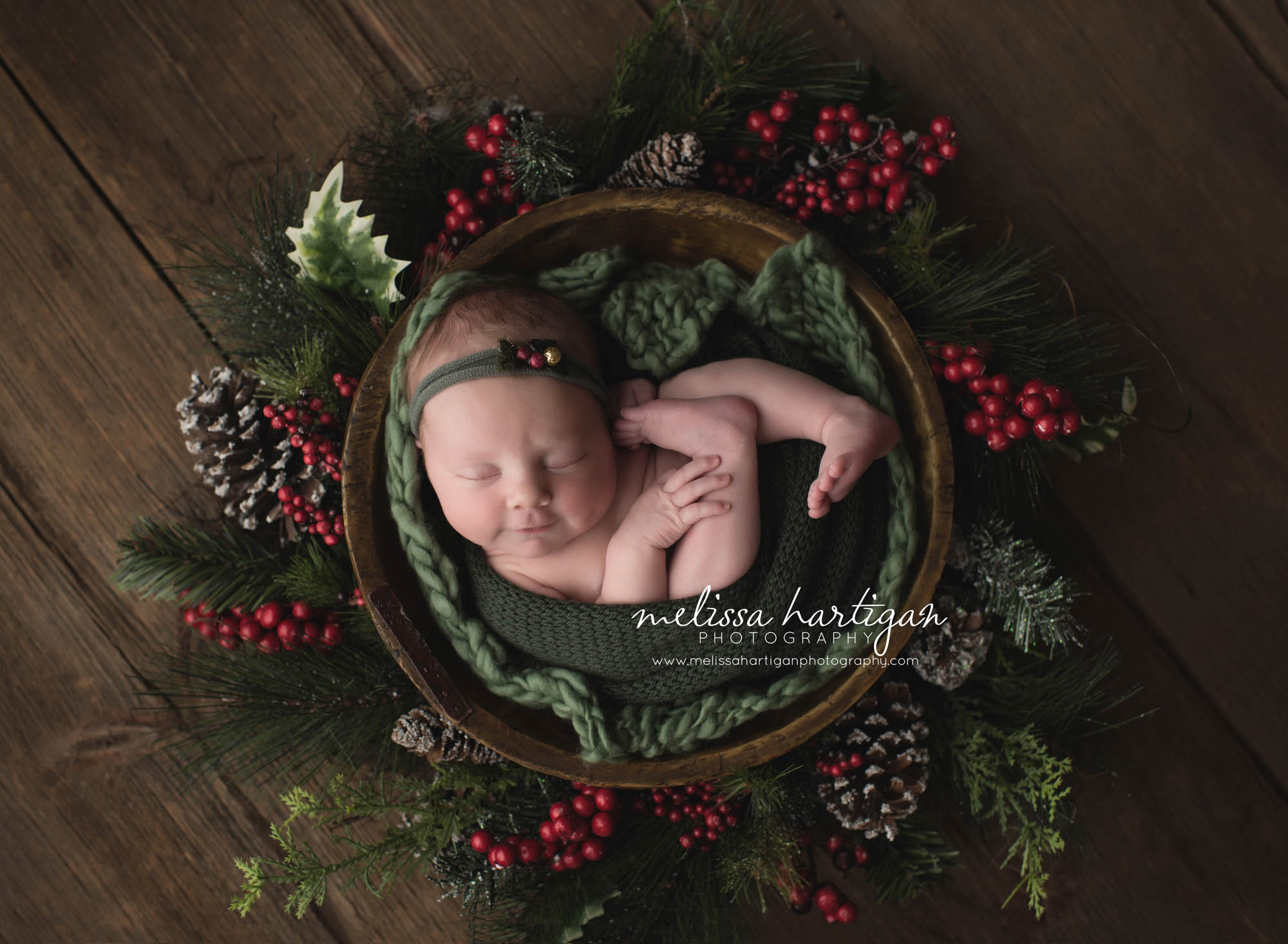 Melissa Hartigan Photography Connecticut Newborn Photographer Coventry Ct Middlefield CT baby Fairfield county Baby girl green headband on green blankets in wooden bowl Christmas wreath sleeping CT newborn session