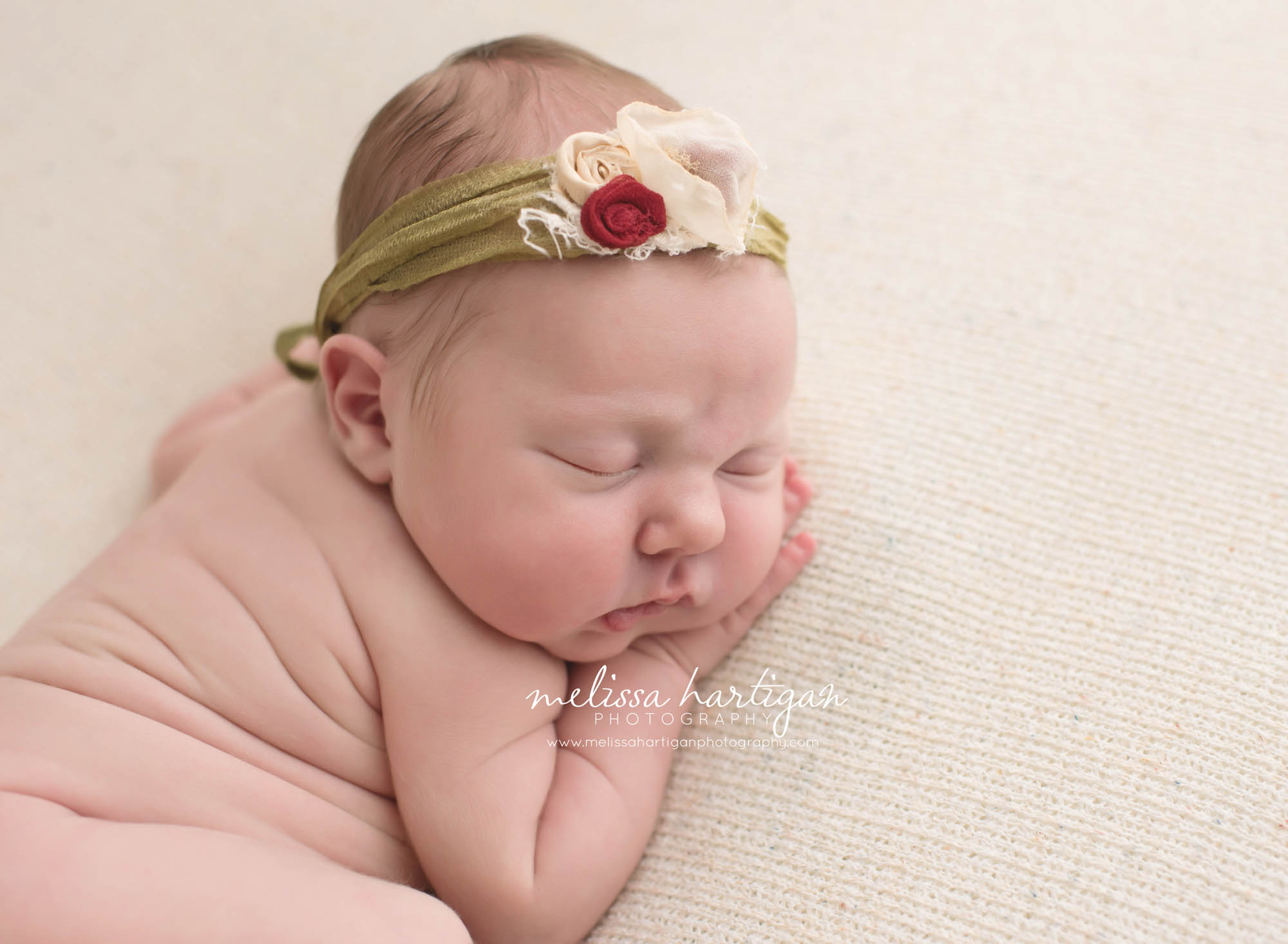 Melissa Hartigan Photography Connecticut Newborn Photographer Coventry Ct Middlefield CT baby Fairfield county Baby girl green headband with flowers sleeping head on hands CT newborn session