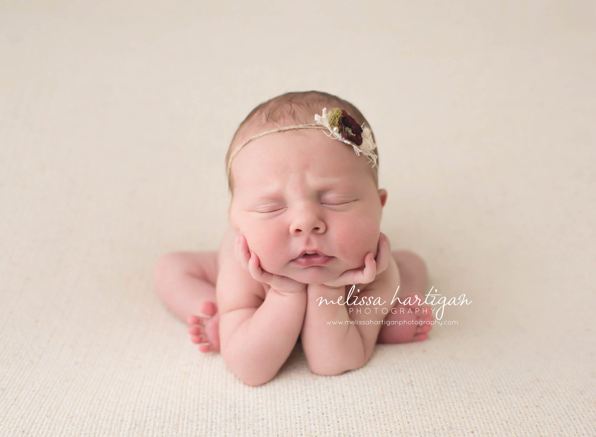 Melissa Hartigan Photography Connecticut Newborn Photographer Coventry Ct Middlefield CT baby Fairfield county Baby girl froggy pose cream headband on pale pink blanket sleeping CT newborn session