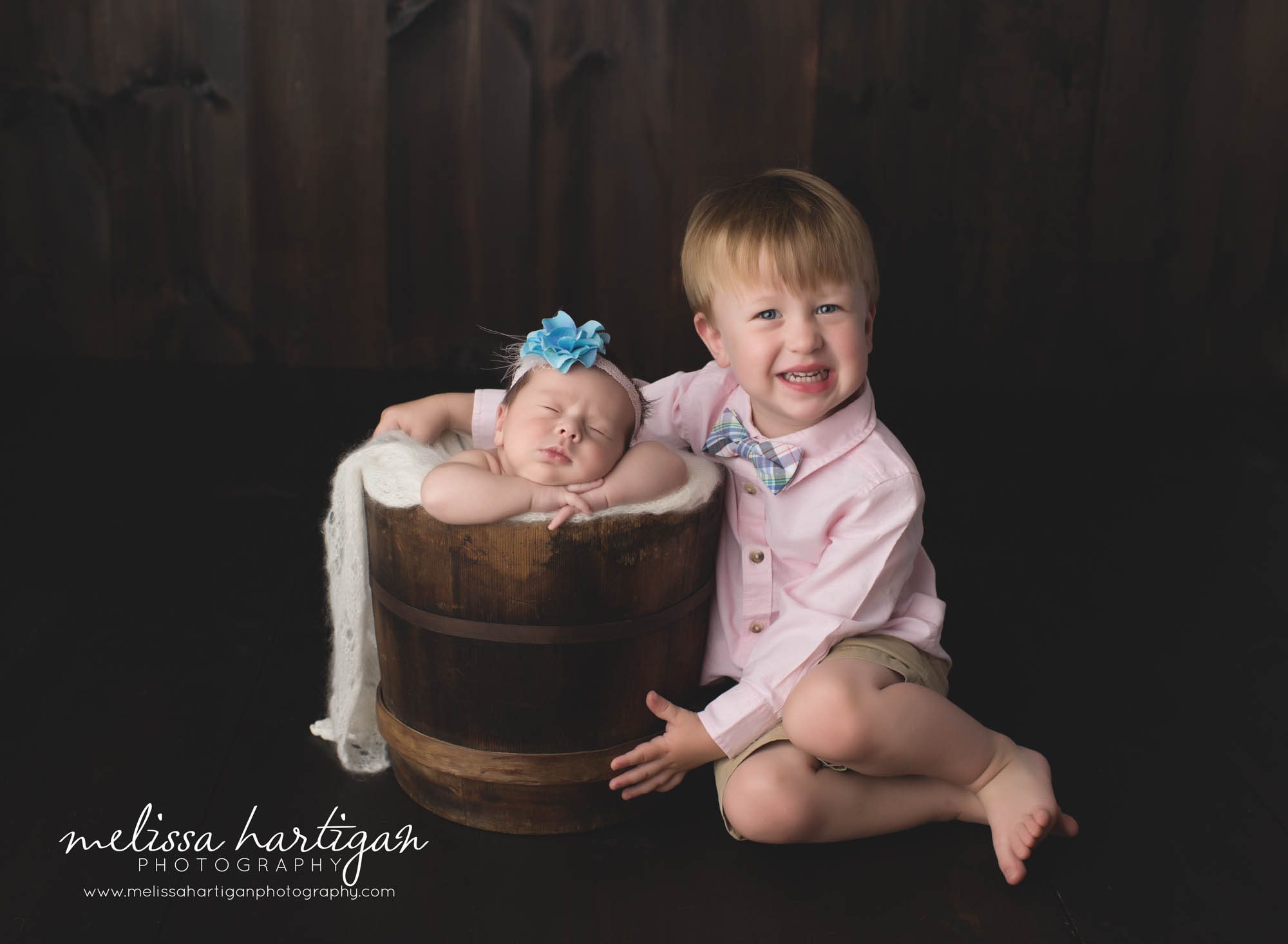 Melissa Hartigan Photography Connecticut Newborn Photographer Coventry Ct Middlefield CT baby Fairfield county Newborn and maternity photography Baby girl blue floral headband in wooden bucket with big brother posed next