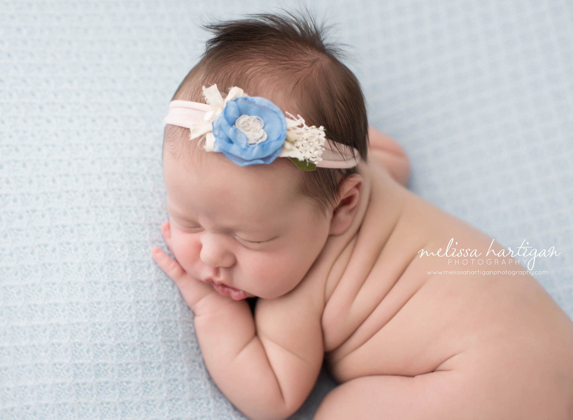 Melissa Hartigan Photography Connecticut Newborn Photographer Coventry Ct Middlefield CT baby Fairfield county Newborn and maternity photography Baby girl blue floral headband sleeping on light blue blanket