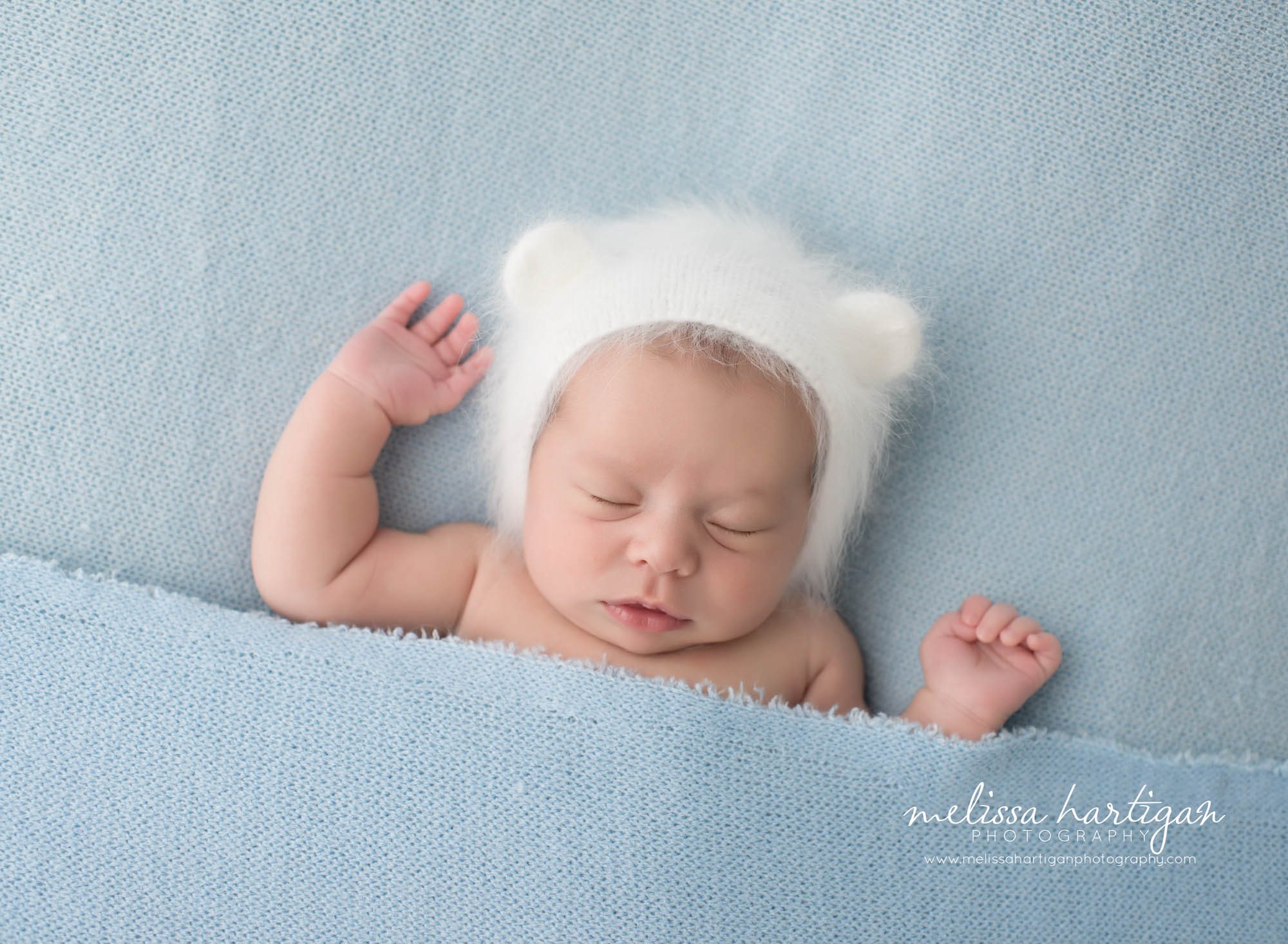 Melissa Hartigan Photography Connecticut Newborn Photographer Coventry Ct Middlefield CT baby Fairfield county Newborn and maternity photography Baby girl bear knit hat sleeping under blue blanket arms out