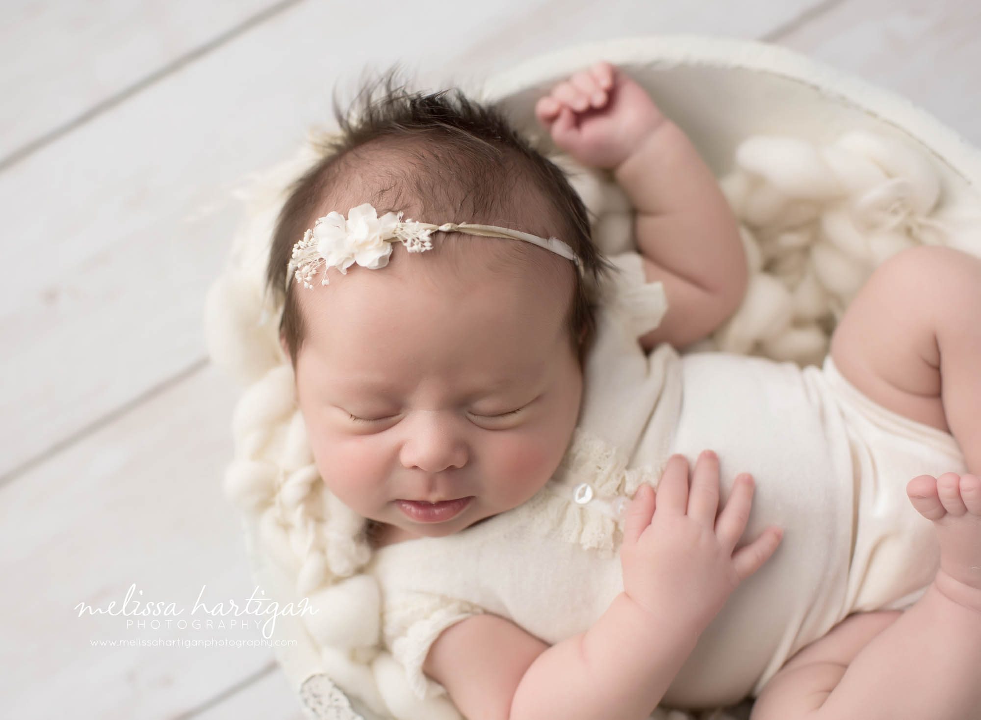 Melissa Hartigan Photography Connecticut Newborn Photographer Coventry Ct Middlefield CT baby Fairfield county Newborn and maternity photography Baby girl cream outfit and headband on cream knit blanket in white bowl sleeping on back