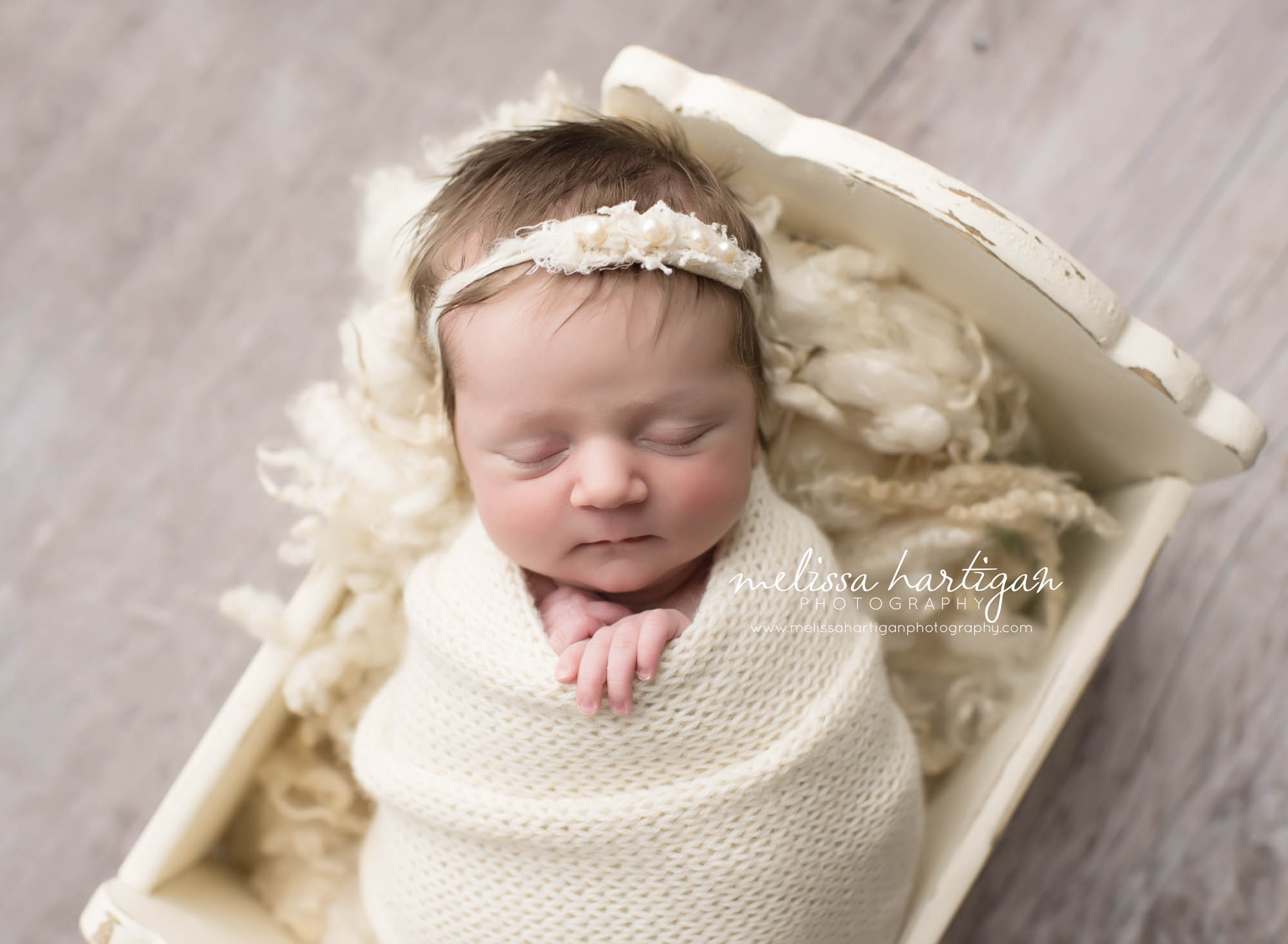 Melissa Hartigan Photography Connecticut Newborn Photographer Coventry Ct Middlefield CT baby Fairfield county Newborn and maternity CT photographer Baby girl white headband and wrap in white wooden bed