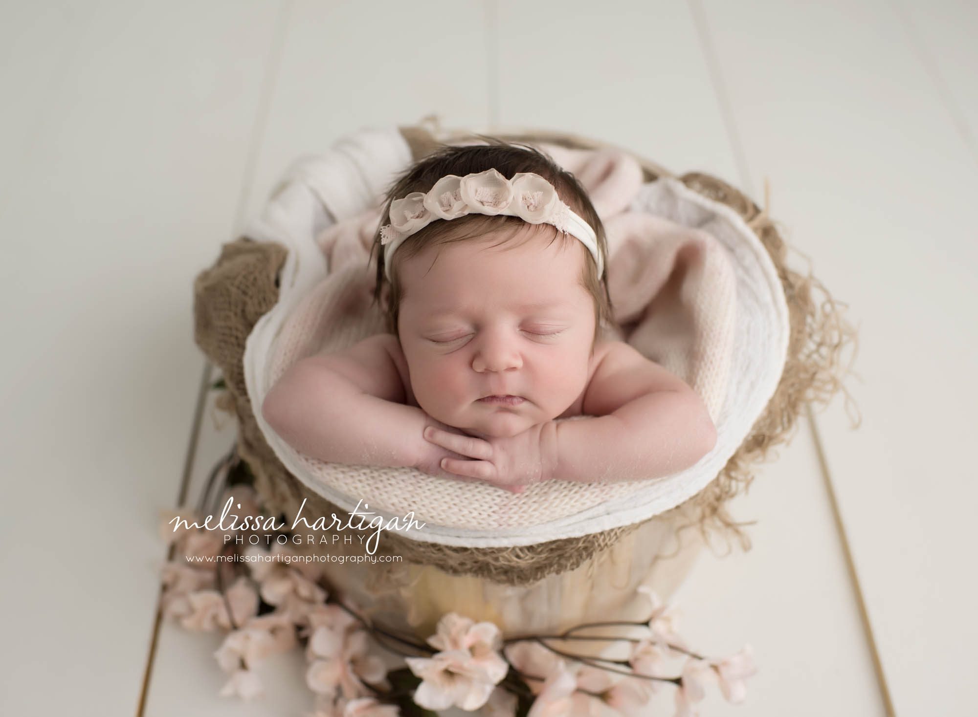 Melissa Hartigan Photography Connecticut Newborn Photographer Coventry Ct Middlefield CT baby Fairfield county Newborn and maternity CT photographer Baby girl white floral headband in wooden bowl with white knit blanket and pale pink flowers