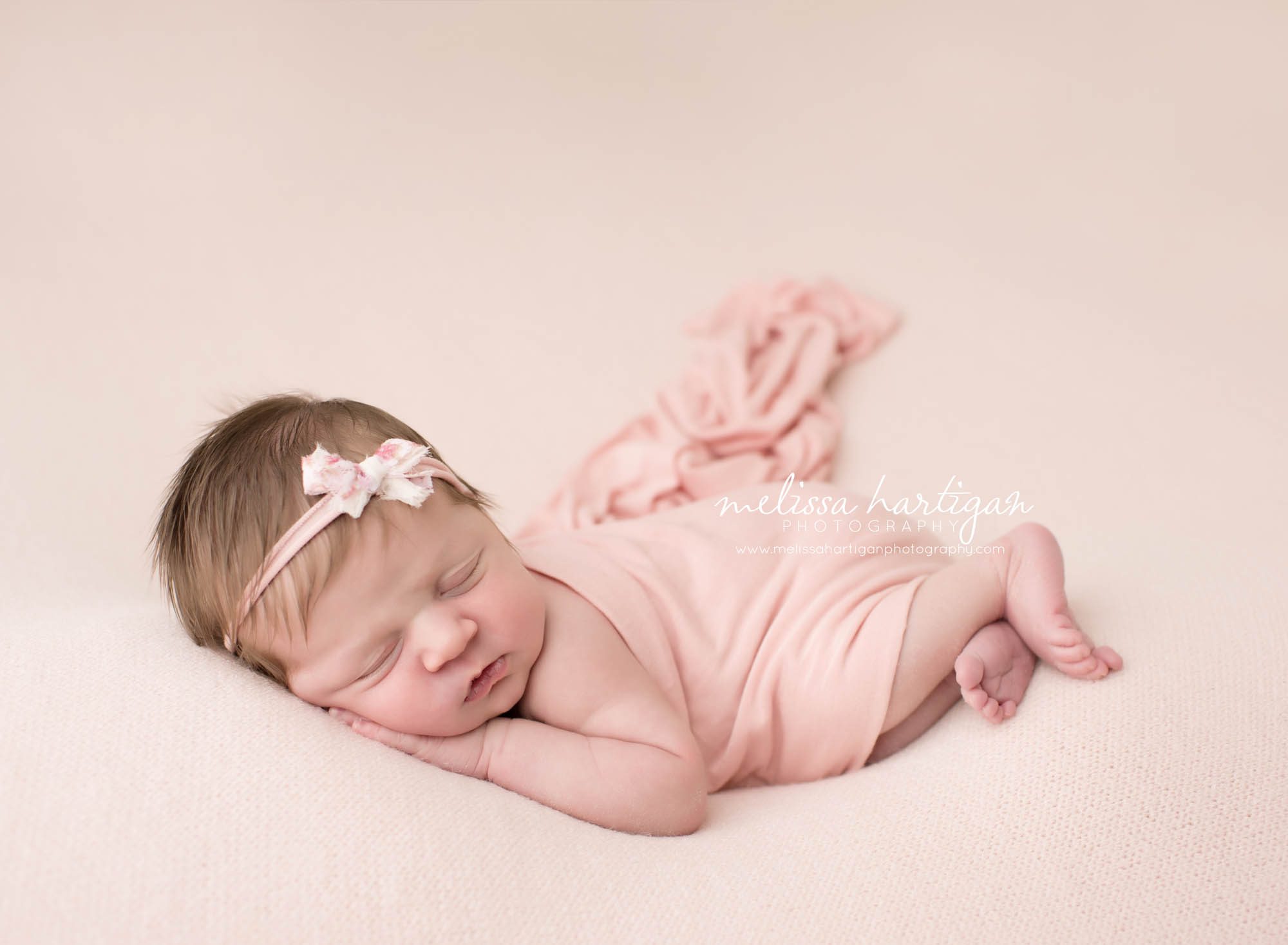 Melissa Hartigan Photography Connecticut Newborn Photographer Coventry Ct Middlefield CT baby Fairfield county Newborn and maternity CT photographer Baby girl pink headband with pink blanket sleeping head on hands