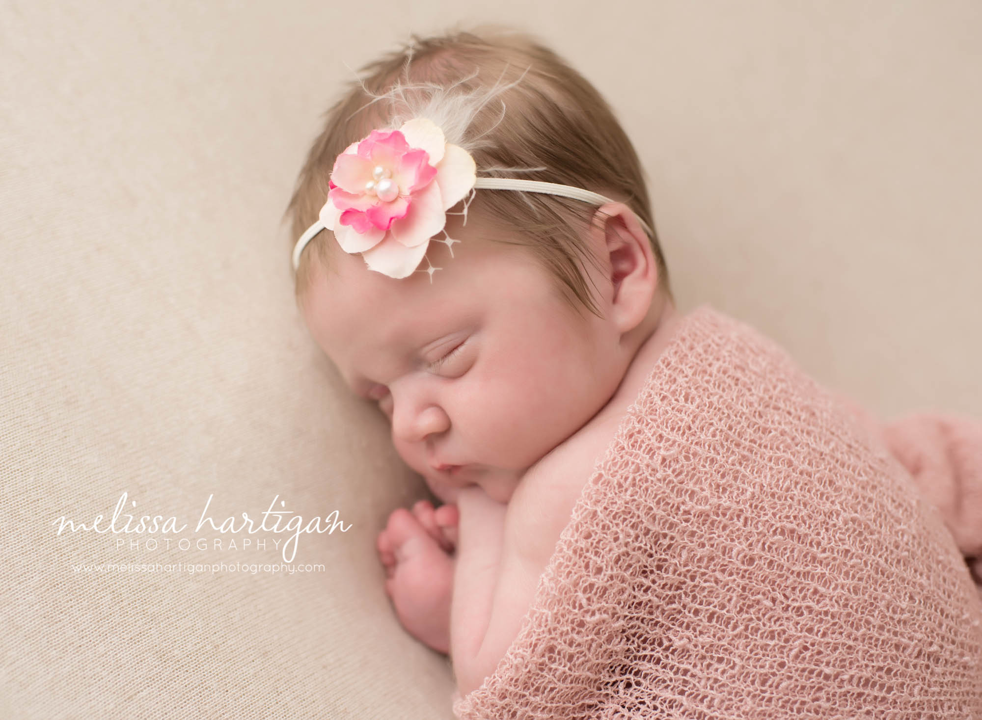 Melissa Hartigan Photography Connecticut Newborn twin Photographer Coventry Ct Middlefield CT baby Fairfield county Newborn and maternity CT photographer Newborn twin photographer baby girl sleeping with pink wrap head on hands wearing pink floral headband