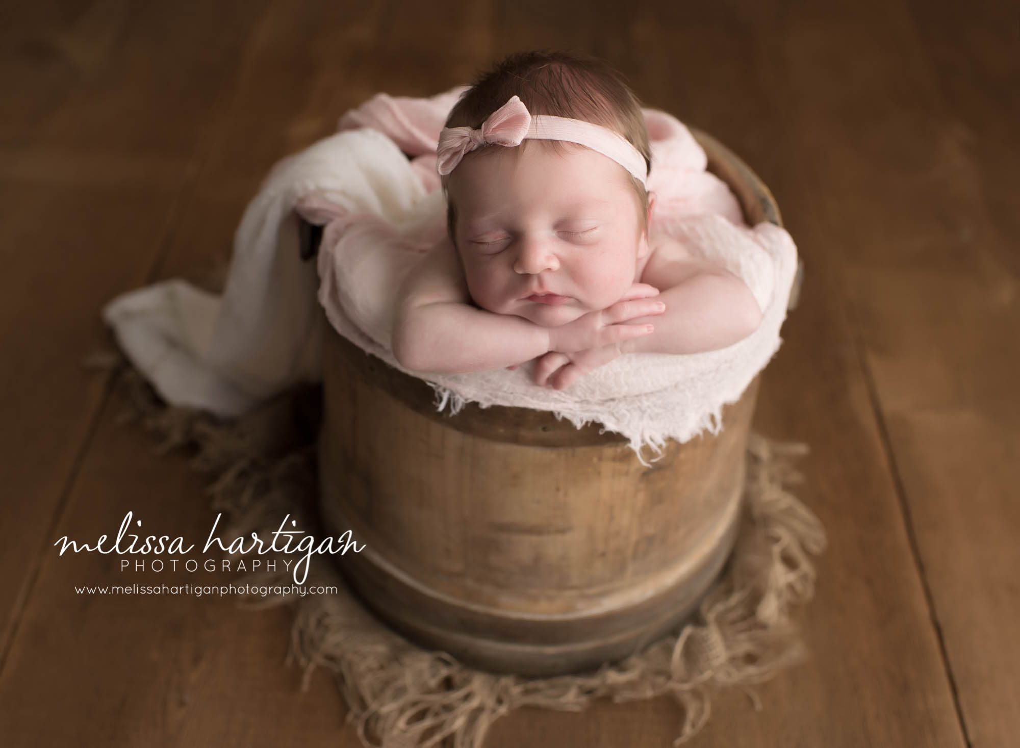 Melissa Hartigan Photography Connecticut Newborn Twin Photographer Coventry Ct Middlefield CT baby Fairfield county Newborn and maternity CT photographer Newborn twin photographer baby girl in wooden basket with pink blanket and headband