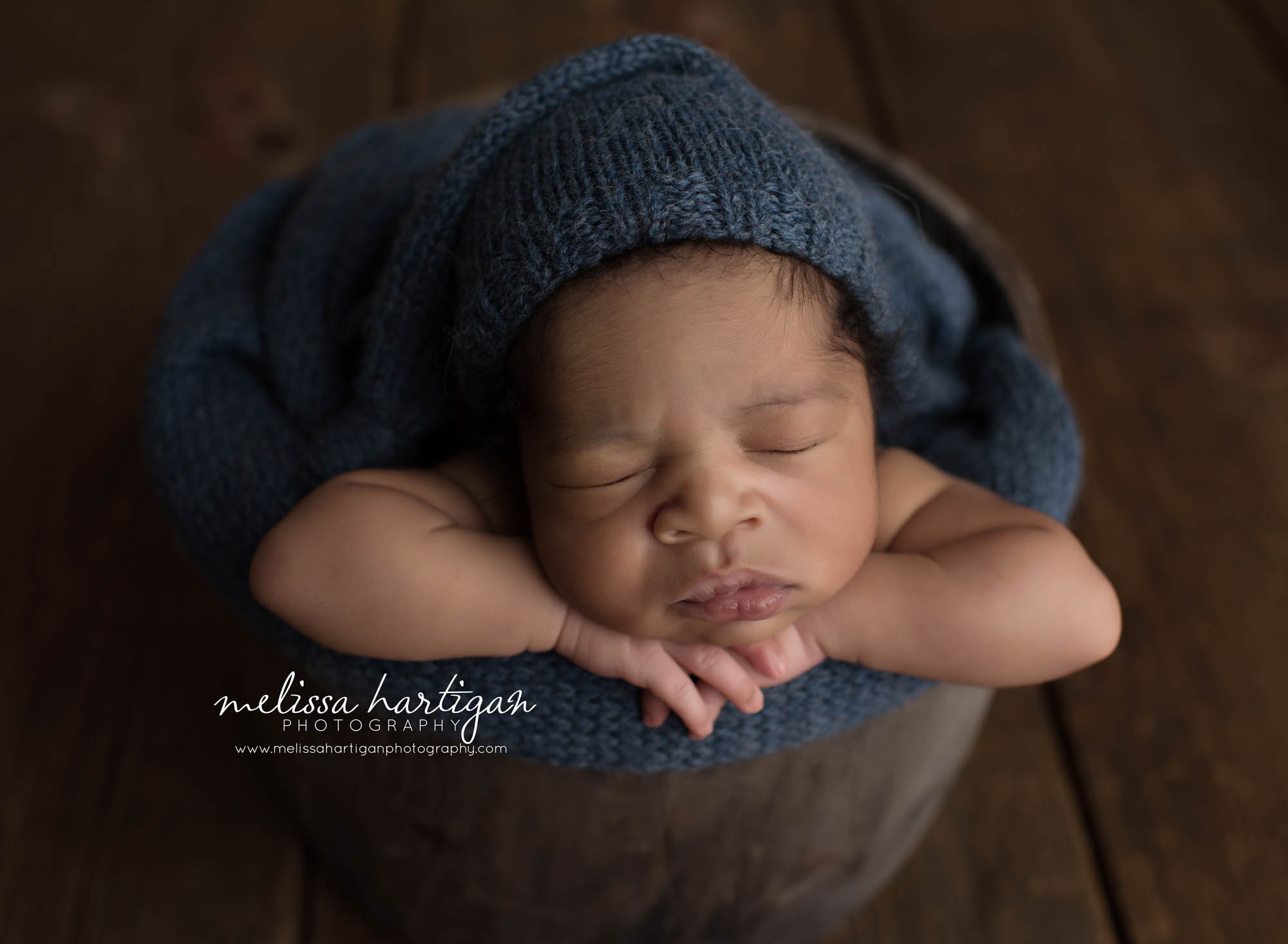 Melissa Hartigan Photography Connecticut Maternity and Newborn CT Photographer Coventry Ct Middlefield CT baby Fairfield county Newborn pose baby boy wooden bucket with dark blue blanket and wearing blue knitted hat