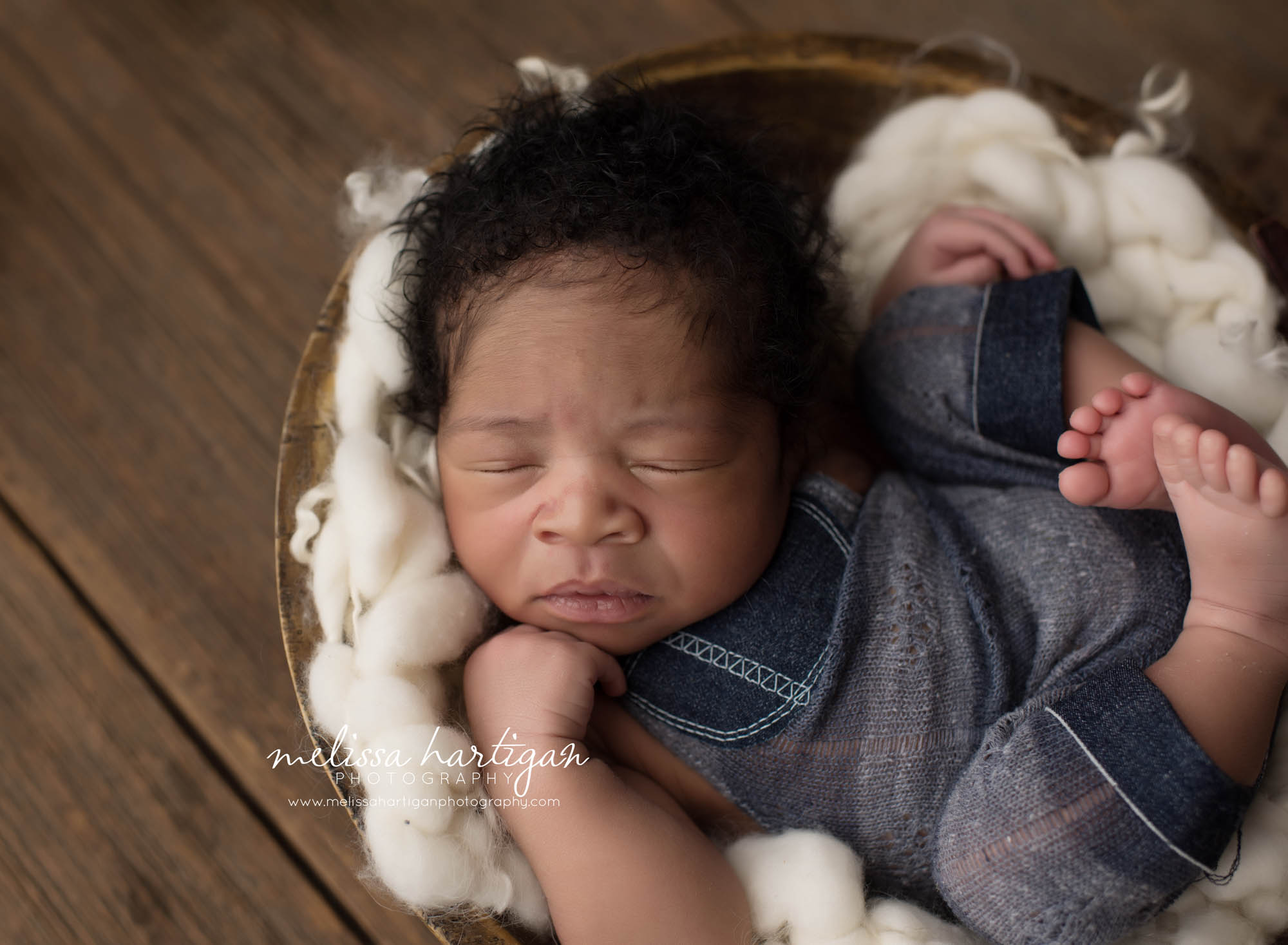 Melissa Hartigan Photography Connecticut Maternity and Newborn CT Photographer Coventry Ct Middlefield CT baby Fairfield county Newborn pose baby boy sleeping in wooden bowl with ivory chunky knitted blanket wearing blue knitted overalls