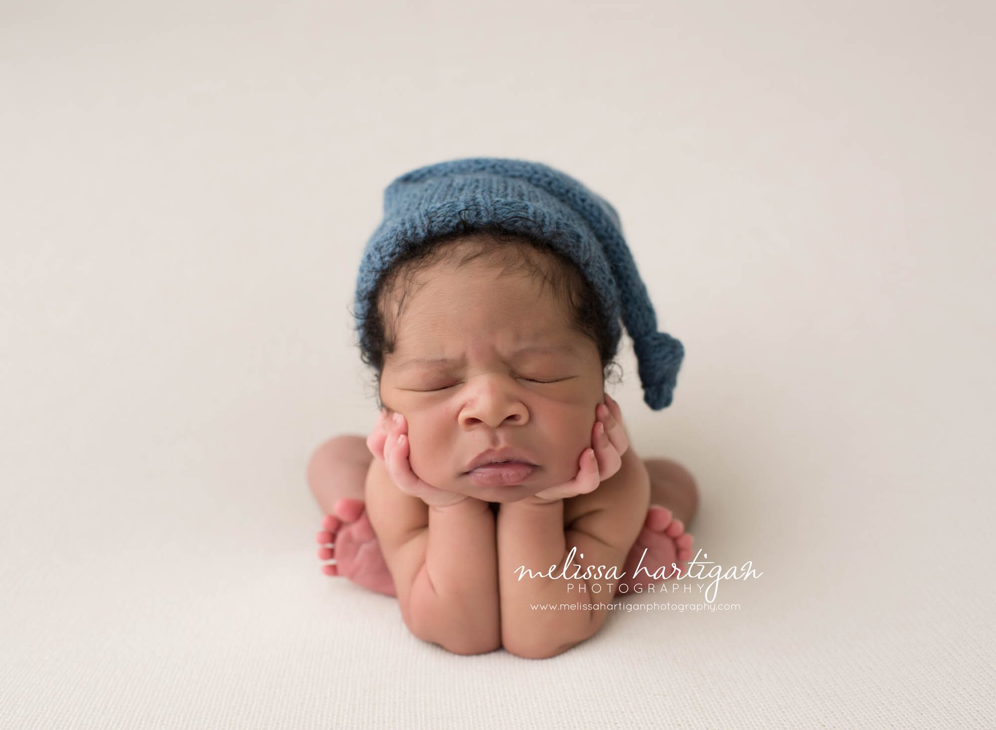 Melissa Hartigan Photography Connecticut Maternity and Newborn CT Photographer Coventry Ct Middlefield CT baby Fairfield county Newborn pose baby boy in froggy pose wearing blue knitted hat