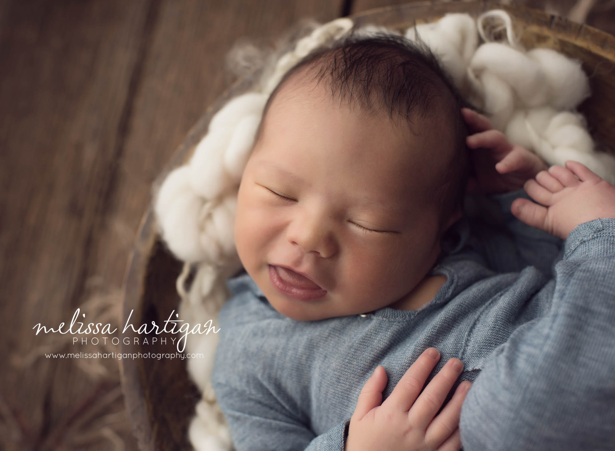 Melissa Hartigan Photography Maternity and Newborn Connecticut Photographer Lucas Newborn Session Baby boy sleeping in wooden bowl on cream knit blanket wearing blue one-piece