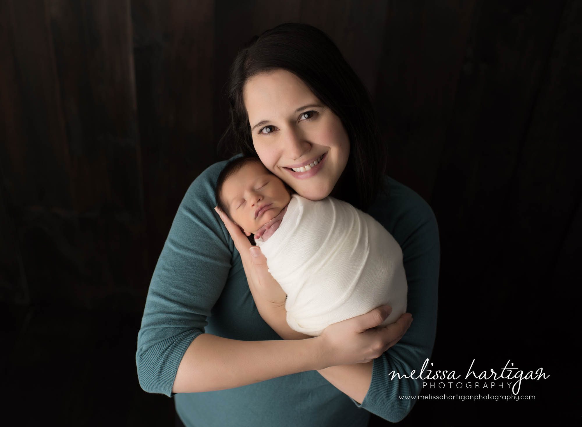 Melissa Hartigan Photography Maternity and Newborn Connecticut Photographer Brayden Mini Newborn Session Baby boy wrapped in cream held by mom smiling