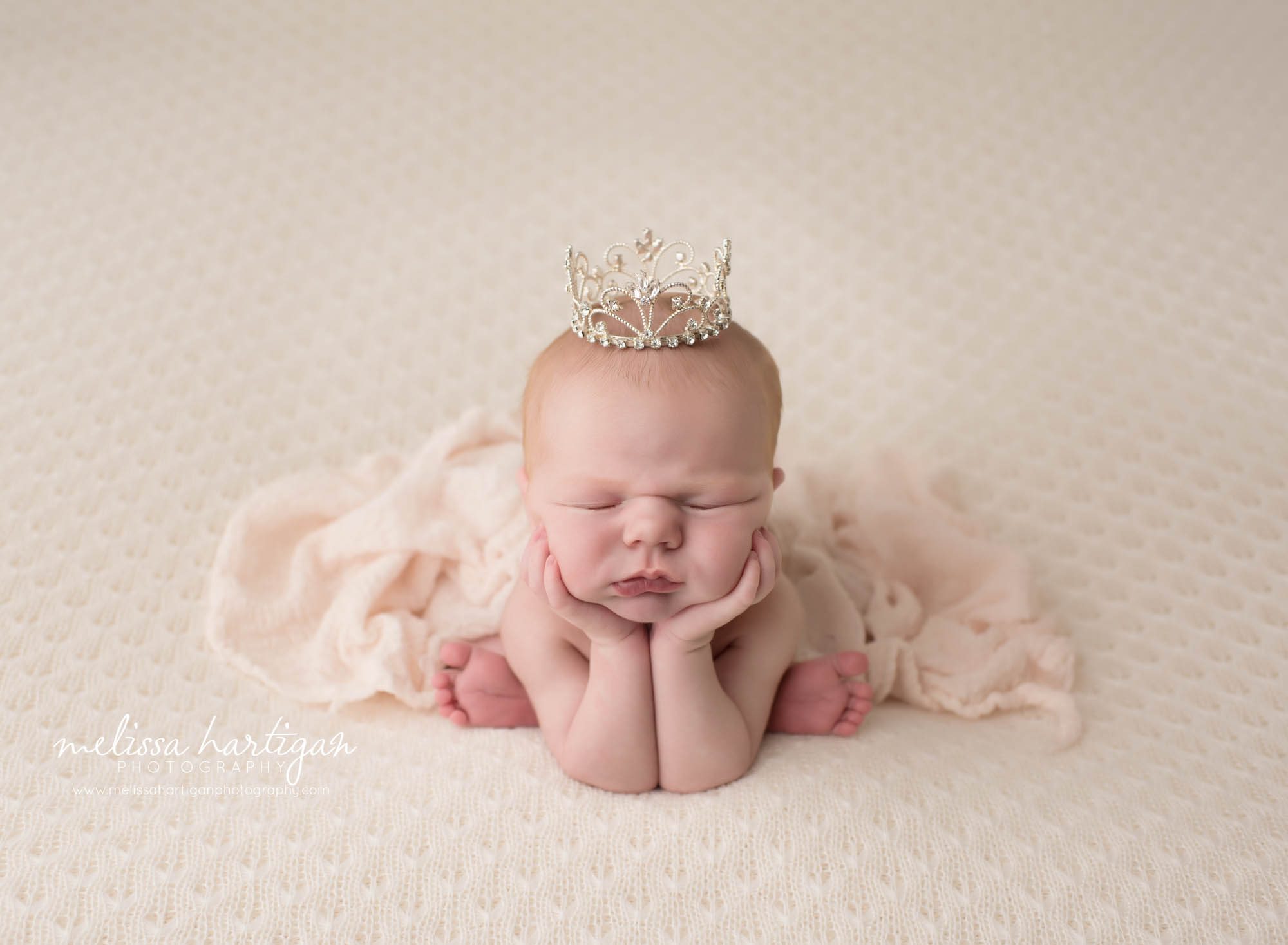 Melissa Hartigan Photography Connecticut Newborn Photographer in Coventry baby girl sleeping in froggy pose wearing tiara under light pink throw