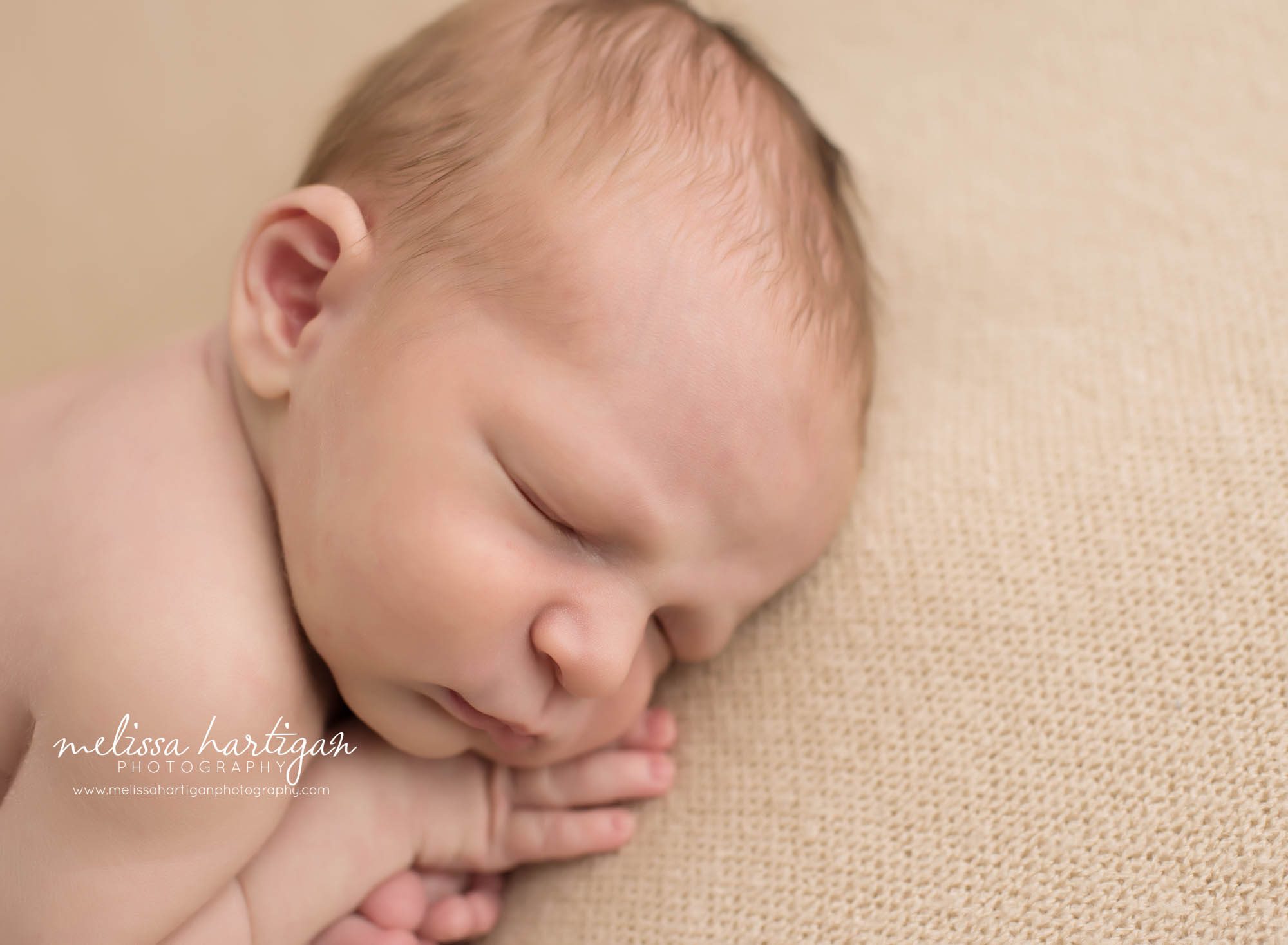 Melissa Hartigan Photography Newborn Photographer Connecticut baby boy sleeping on tan blanket close-up