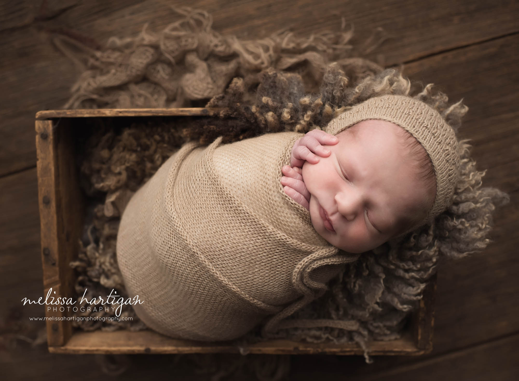 Melissa Hartigan Photography Newborn Photographer Connecticut baby boy sleeping in wooden crate wrapped in tan with matching kit hat