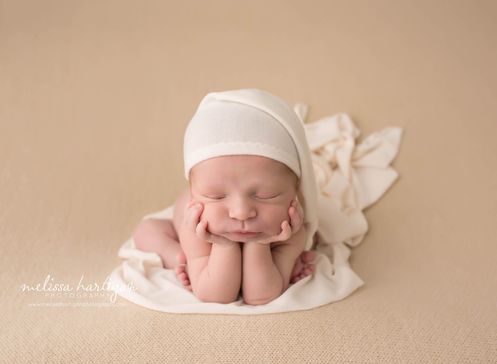 Melissa Hartigan Photography Newborn Photographer Connecticut baby boy in froggy pose wearing white knit hat on matching wrap sleeping