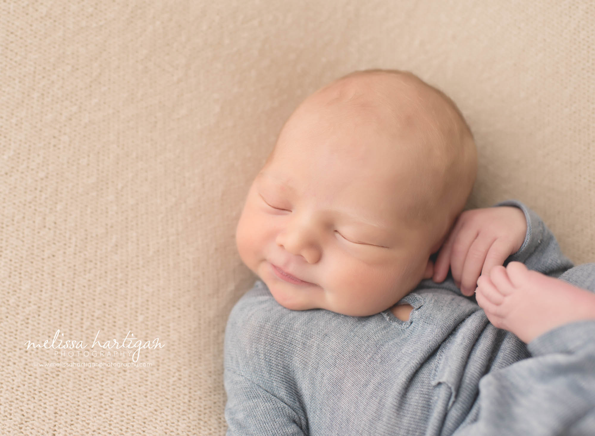 Melissa Hartigan Photography CT Newborn Photographer Braeden Newborn Session baby boy sleeping wearing knit blue onesie close-up