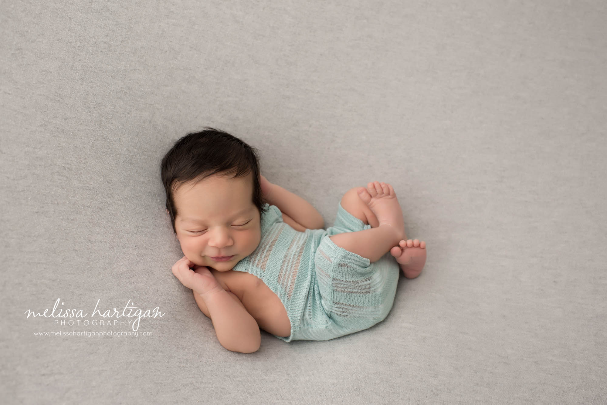 Melissa Hartigan Photography CT Newborn Photographer East Hartford baby boy sleeping smiling wearing light blue knit overalls