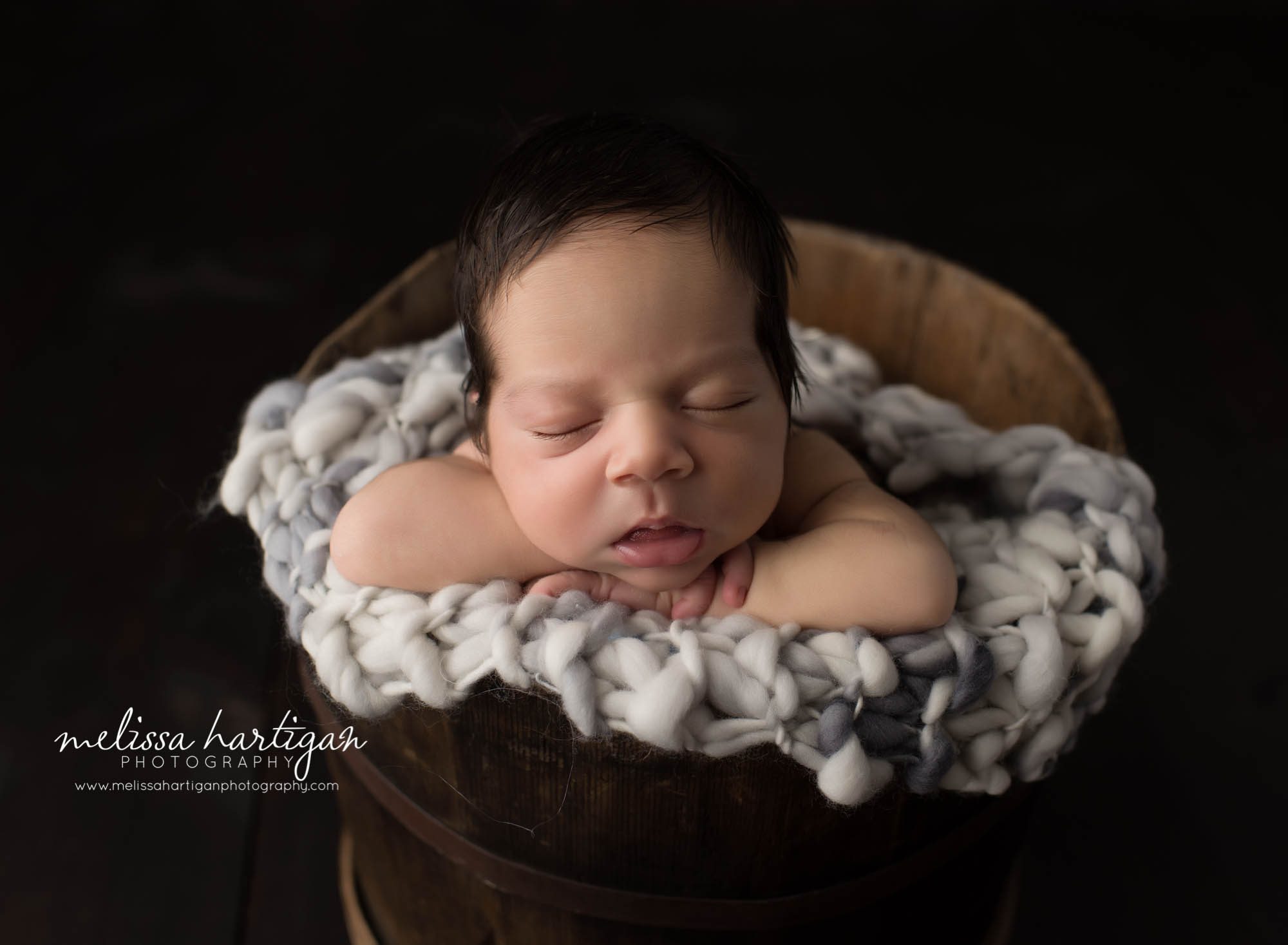 Melissa Hartigan Photography CT Newborn Photographer East Hartford baby boy sleeping in wooden bucket with white and gray blanket