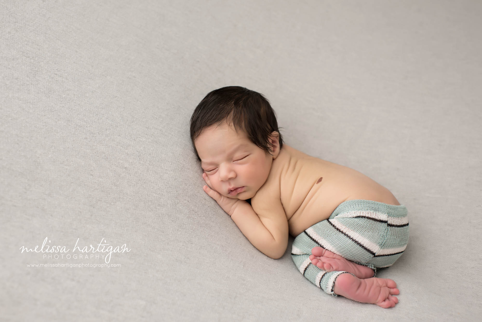 Melissa Hartigan Photography CT Newborn Photographer East Hartford baby boy sleeping on blue blanket wearing blue and white striped pants
