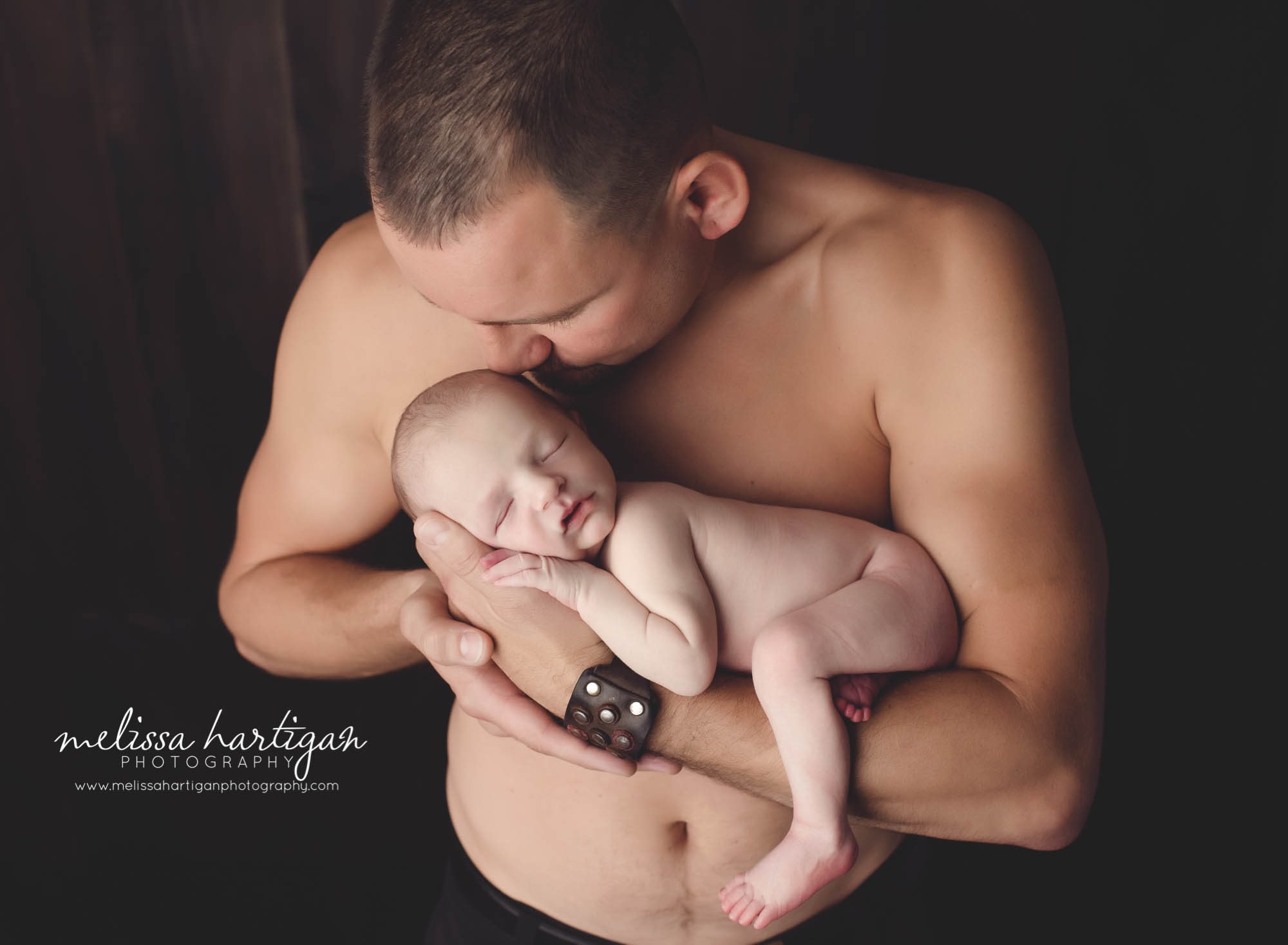 Melissa Hartigan Photography CT Newborn Photographer Stafford baby boy sleeping naked on father's arms with father shirtless and smelling his head