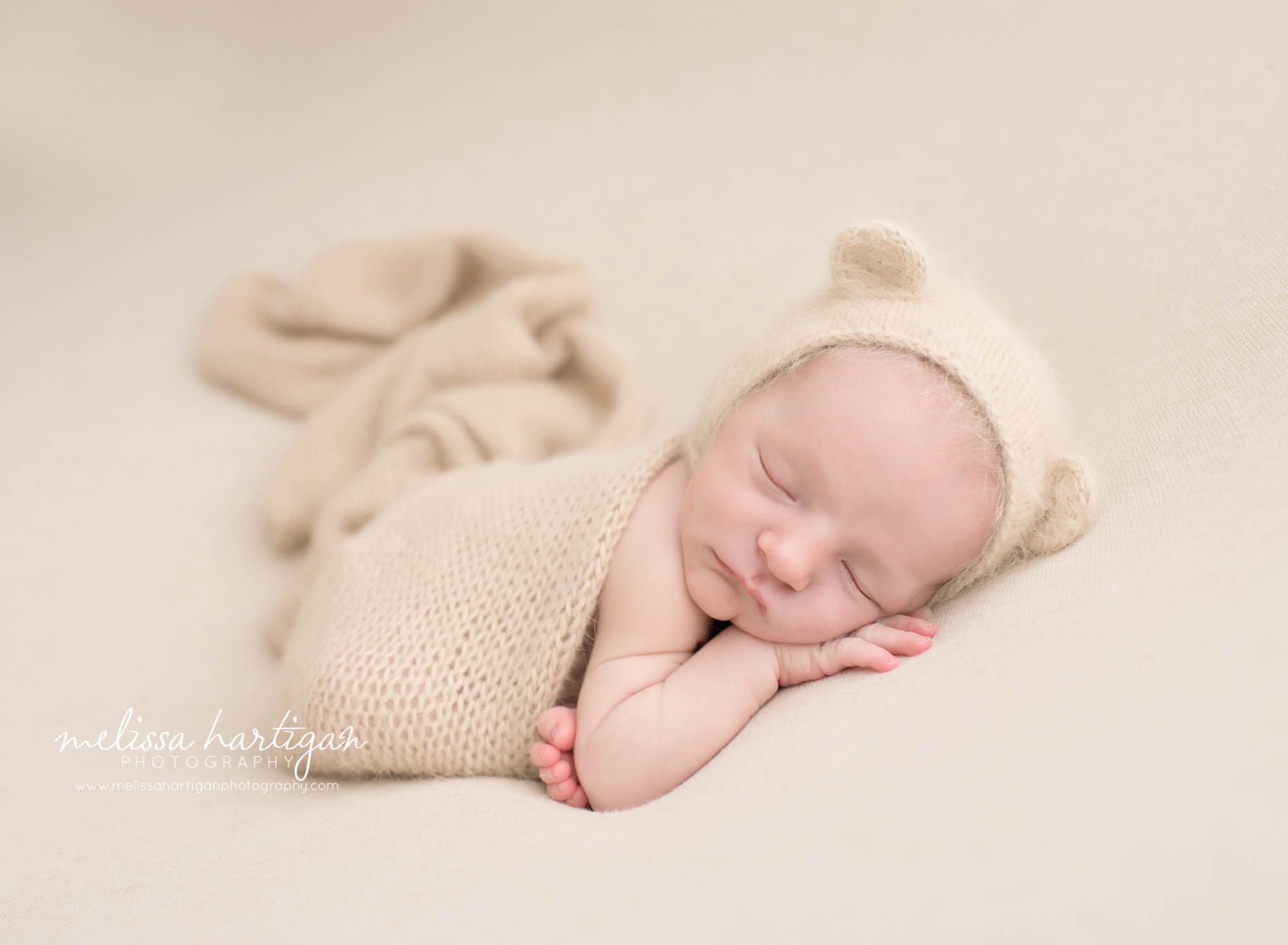 Melissa Hartigan Photography CT Newborn Photographer Stafford baby boy sleeping wearing cream knit ear with ears and matching blanket