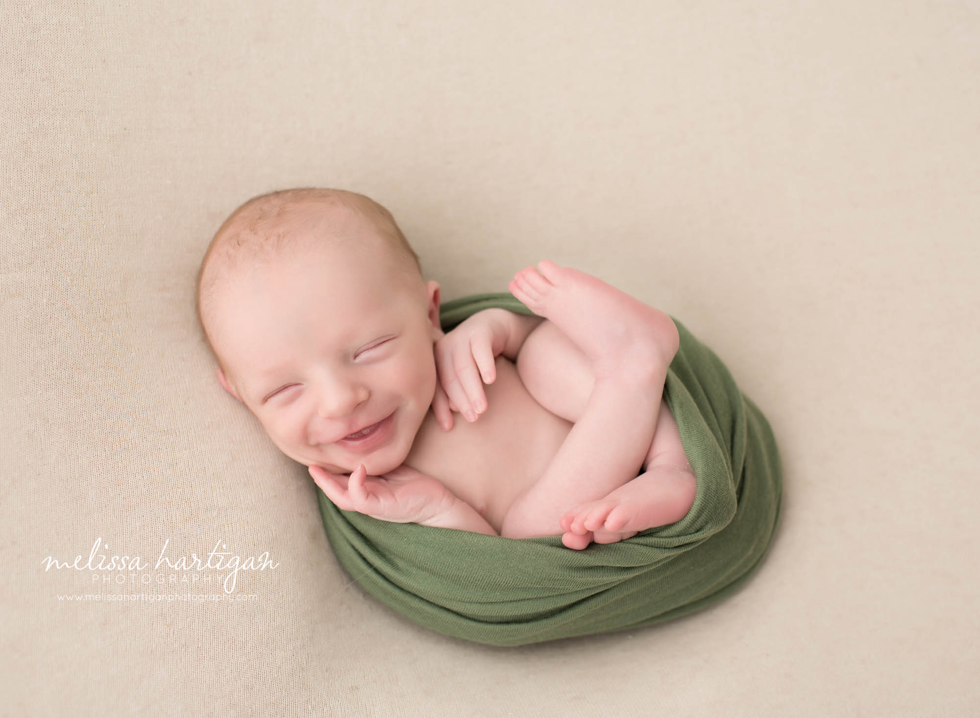 Melissa Hartigan Photography CT Newborn Photographer Stafford baby boy sleeping wrapped in green smiling