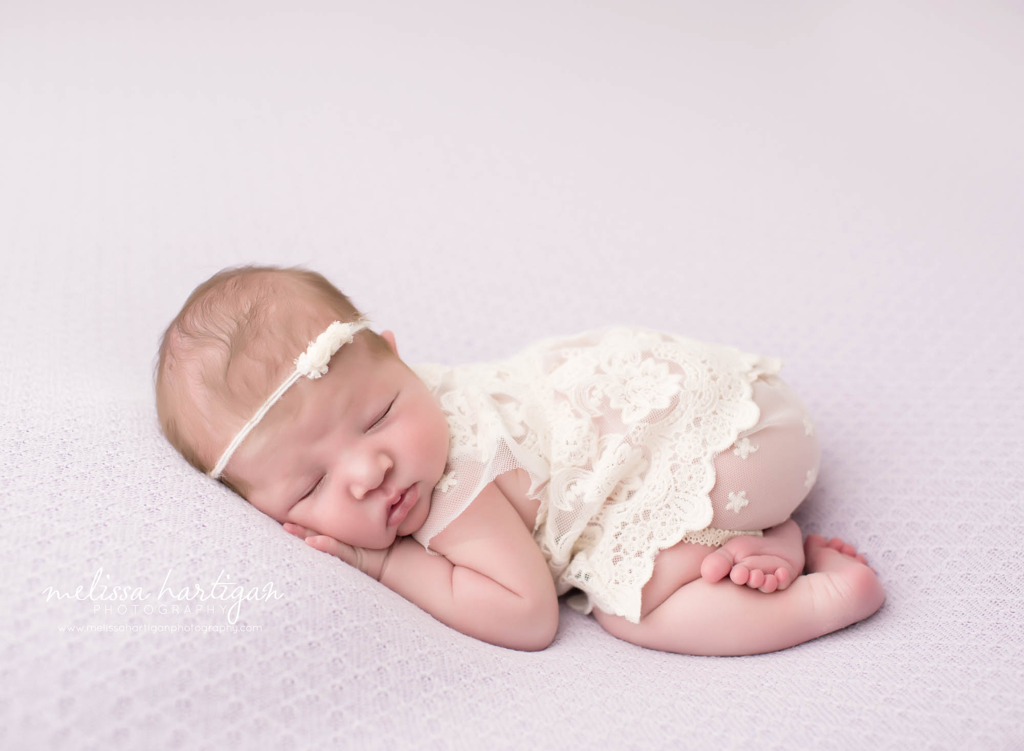 Melissa Hartigan Photography CT Newborn Photographer Ashford baby girl sleeping wearing white lace onesie and white headband