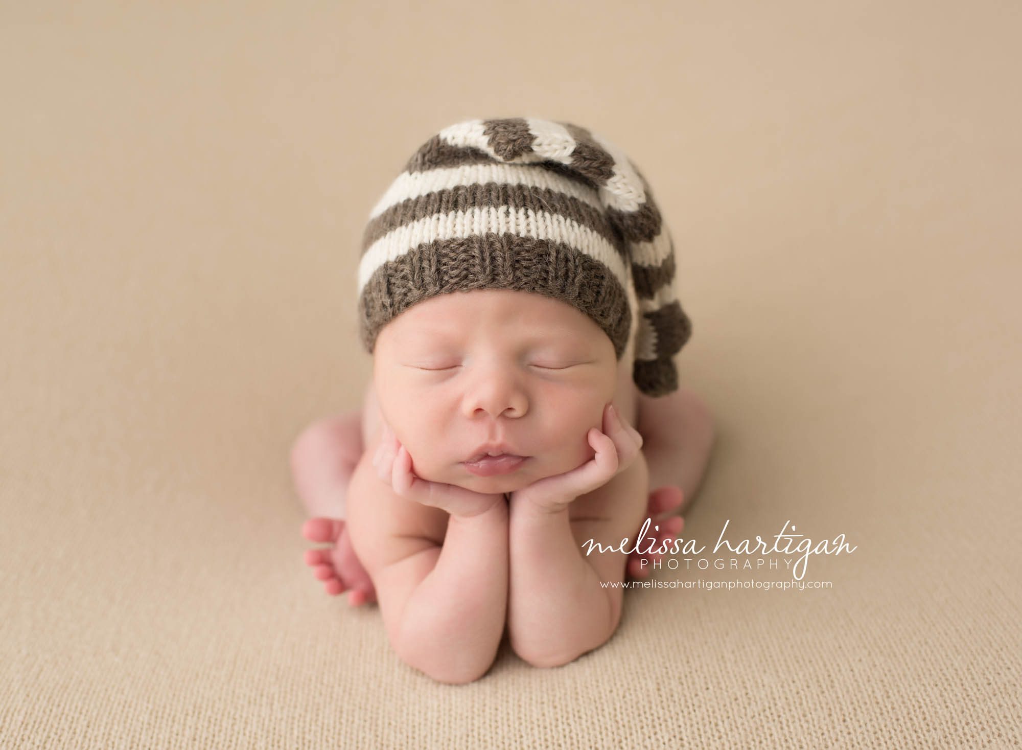 Melissa Hartigan Photography CT Newborn Photographer Taave CT Newborn Session baby boy sleeping in froggy pose wearing cream and gray striped knit hat
