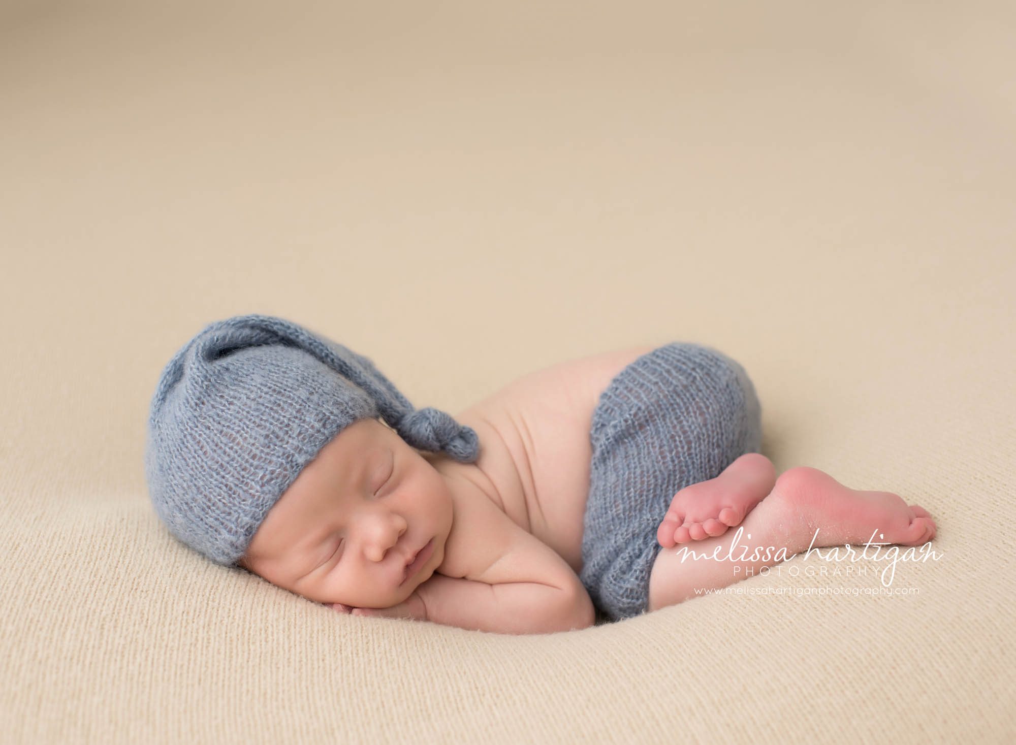 Melissa Hartigan Photography CT Newborn Photographer Taave CT Newborn Session baby boy sleeping wearing blue knit hat and pants
