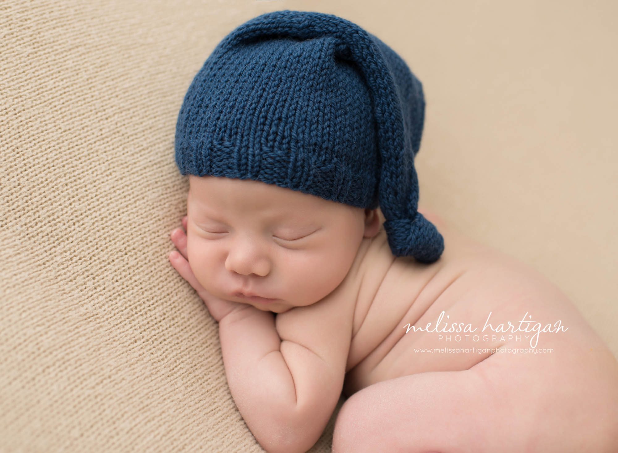 Melissa Hartigan Photography CT Newborn Photographer Taave CT Newborn Session baby boy sleeping on tan blanket with blue knit hat