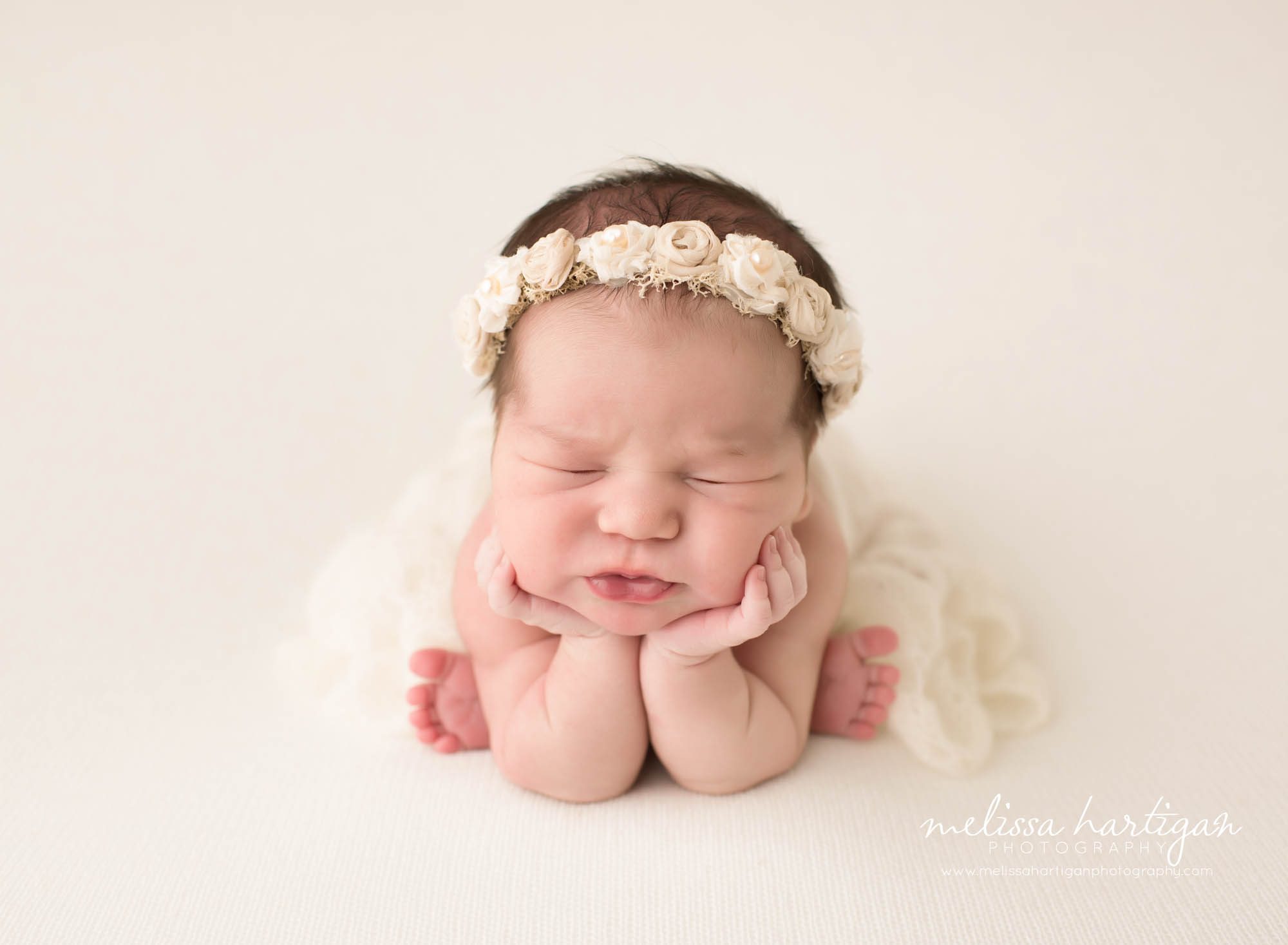 Melissa Hartigan Photography CT Newborn Photographer Emerson CT Newborn Session baby girl sleeping in froggy pose wearing cream floral headband