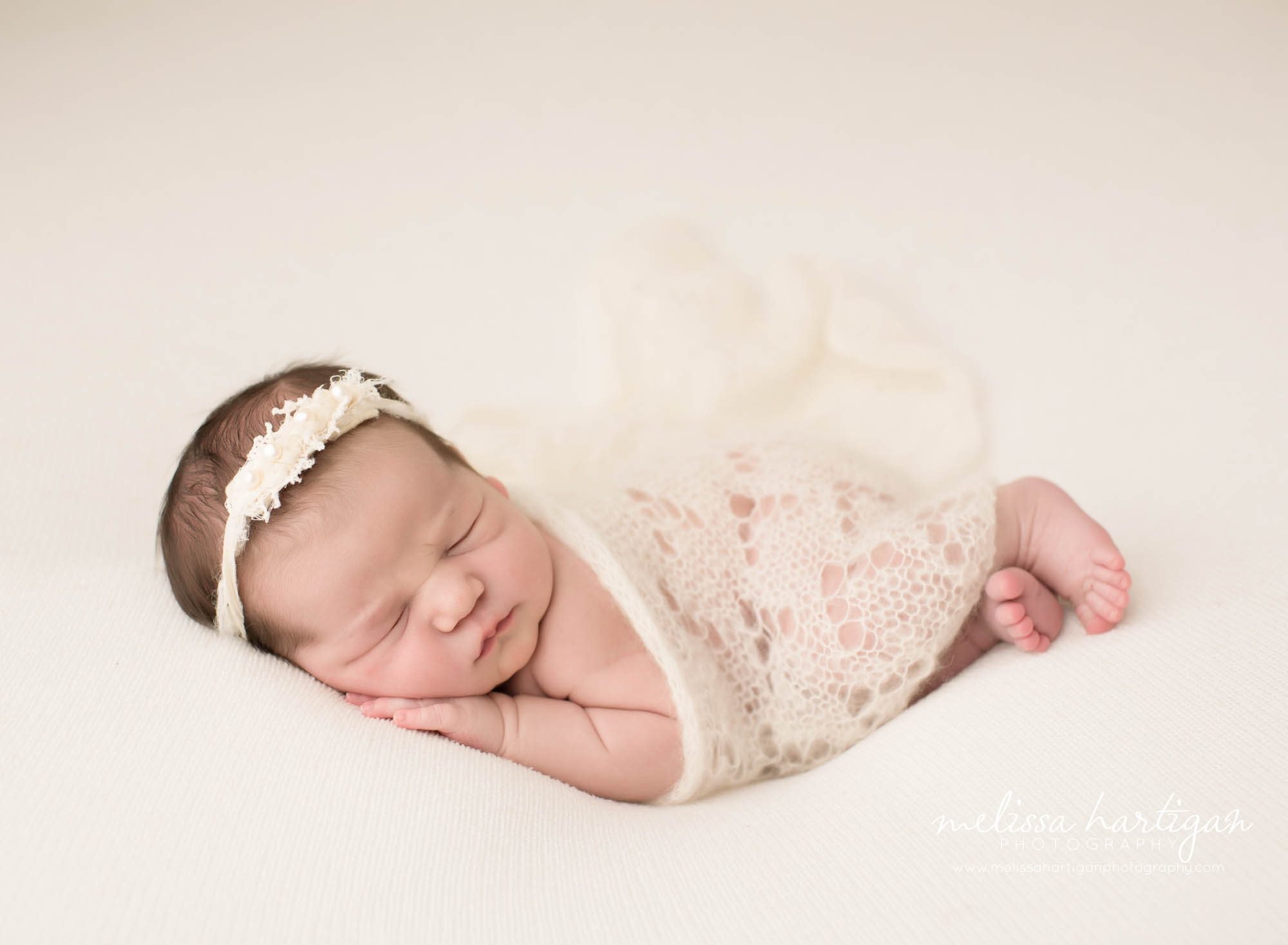 Melissa Hartigan Photography CT Newborn Photographer Emerson CT Newborn Session baby girl sleeping wearing cream headband with cream knit wrap