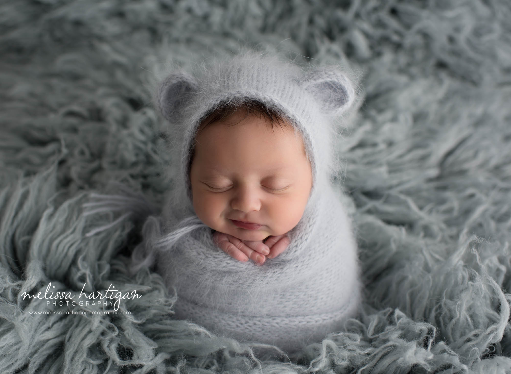 Leila CT Newborn Session baby girl sleeping wrapped in light blue knit with matching hat with ears