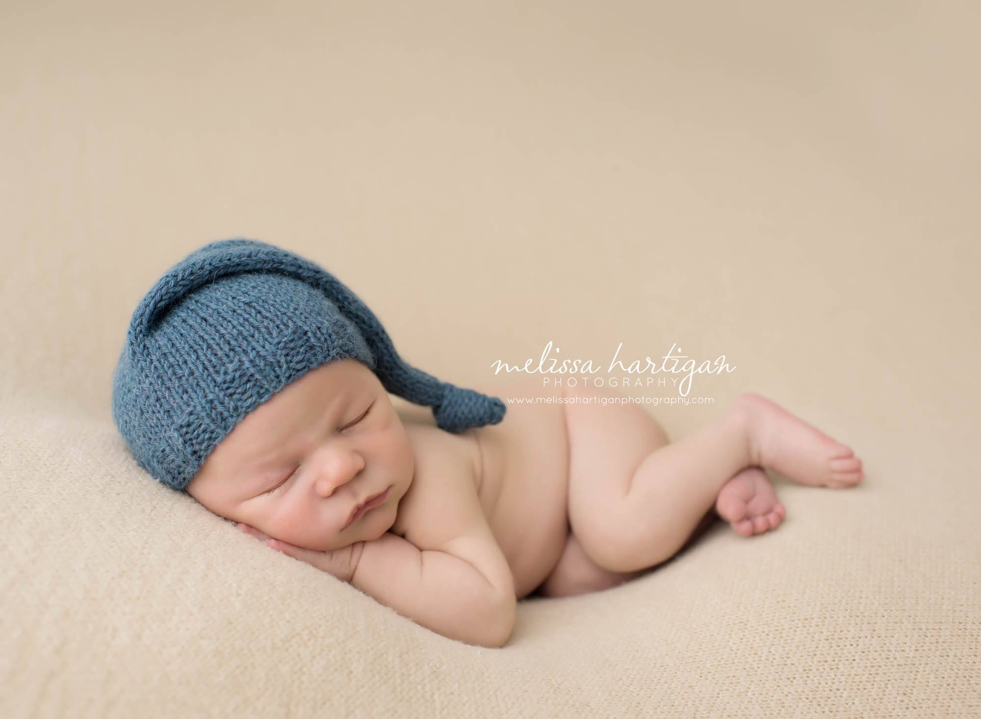 Newborn Session CT baby boy sleeping laying wearing blue knit hat
