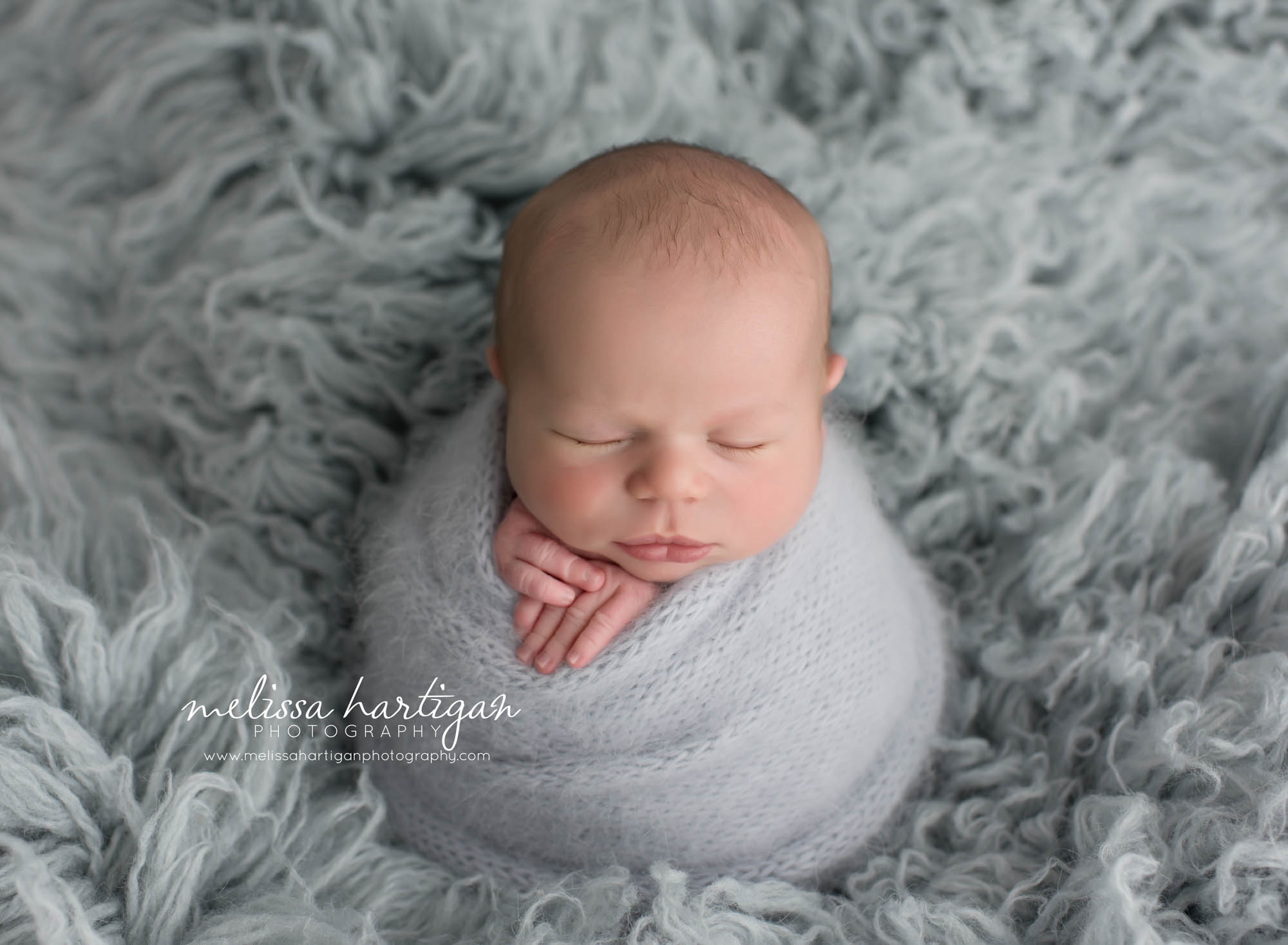 Newborn Session CT baby boy sleeping wrapped in light blue wrap