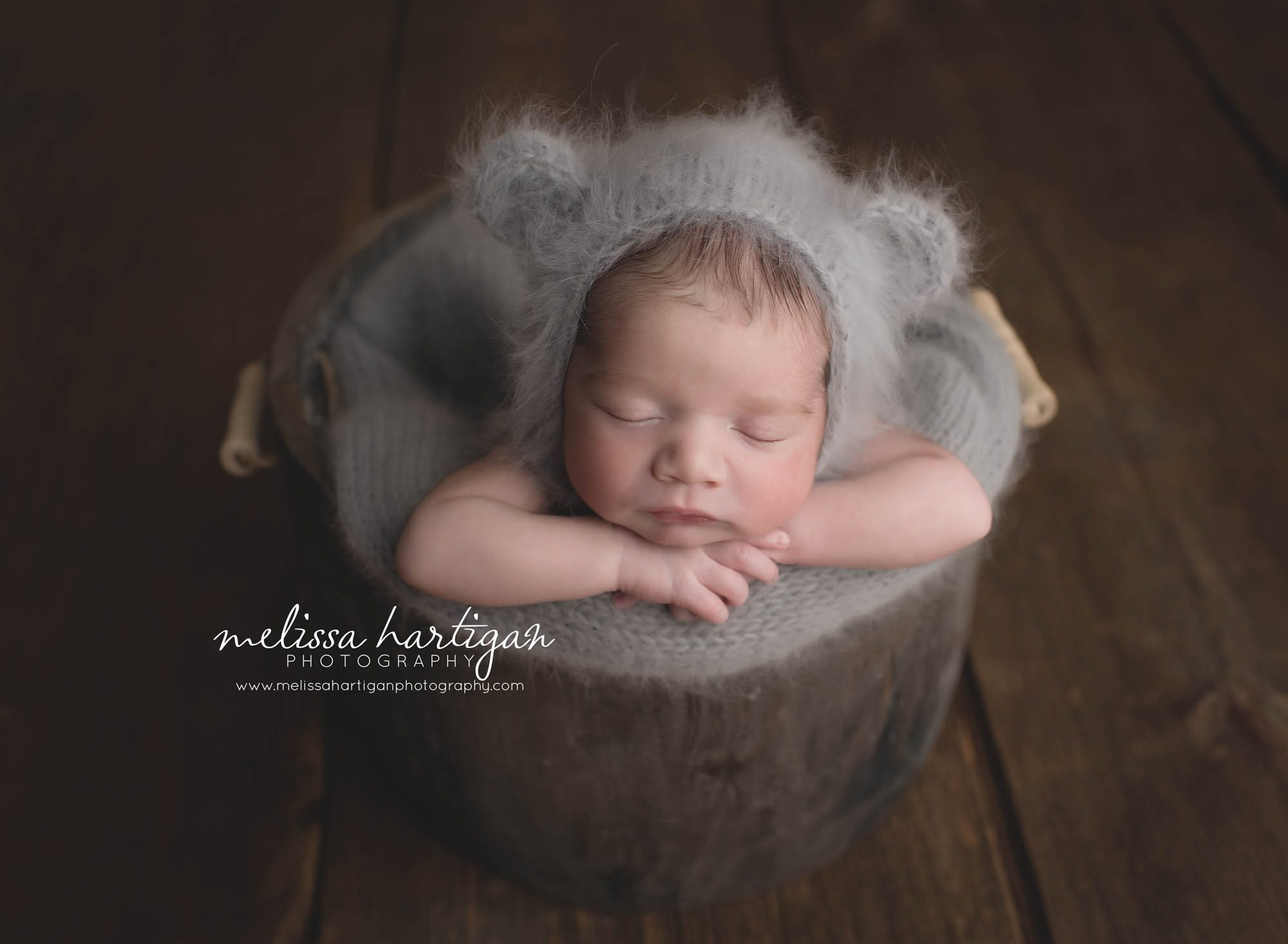 CT Newborn Photographer baby boy sleeping in wooden bucket with gray knit hat