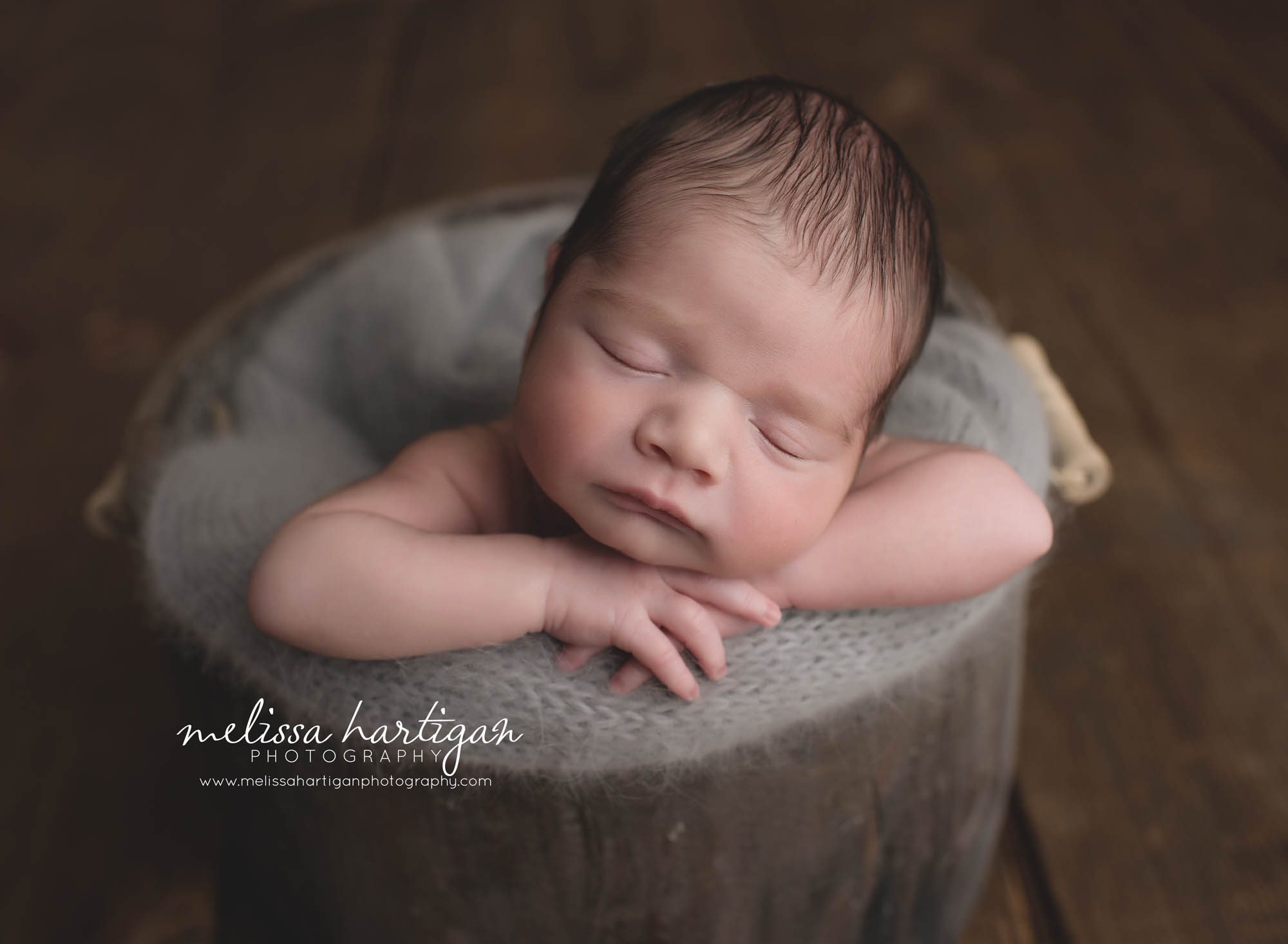 CT Newborn Photographer baby boy sleeping in wooden barrel with gray blanket