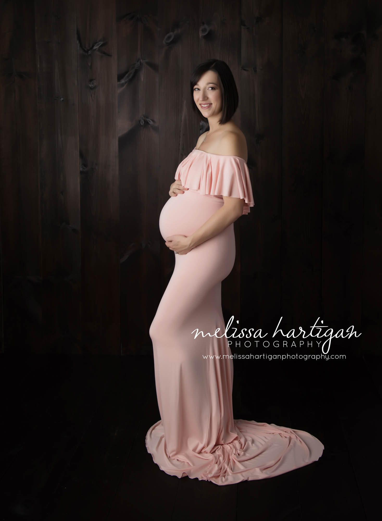 CT Maternity Photographer maternity pose mom cradling baby bump in pink maternity gown