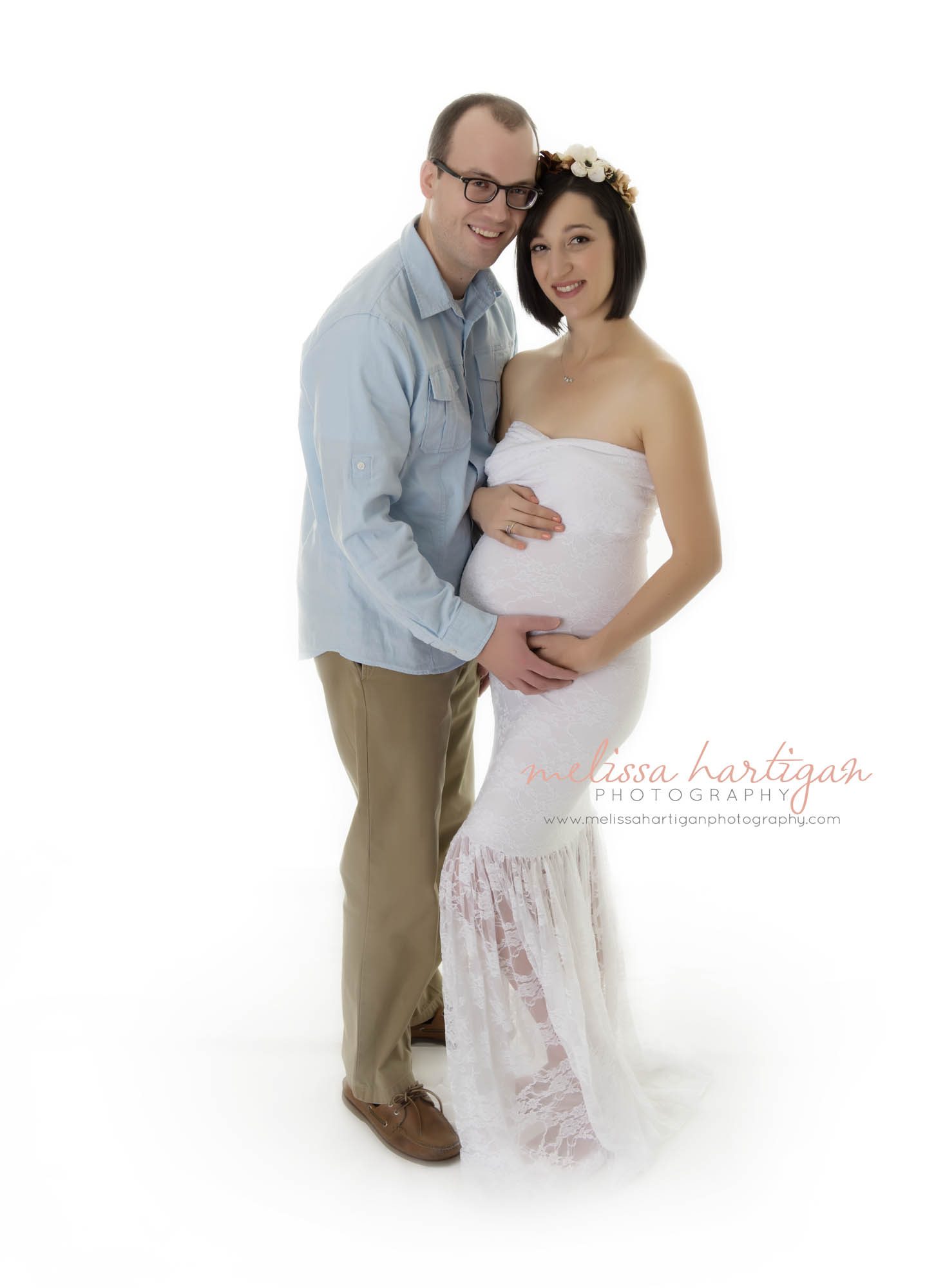 CT Maternity Photographer maternity pose mom cradling baby bump in white dress with husband