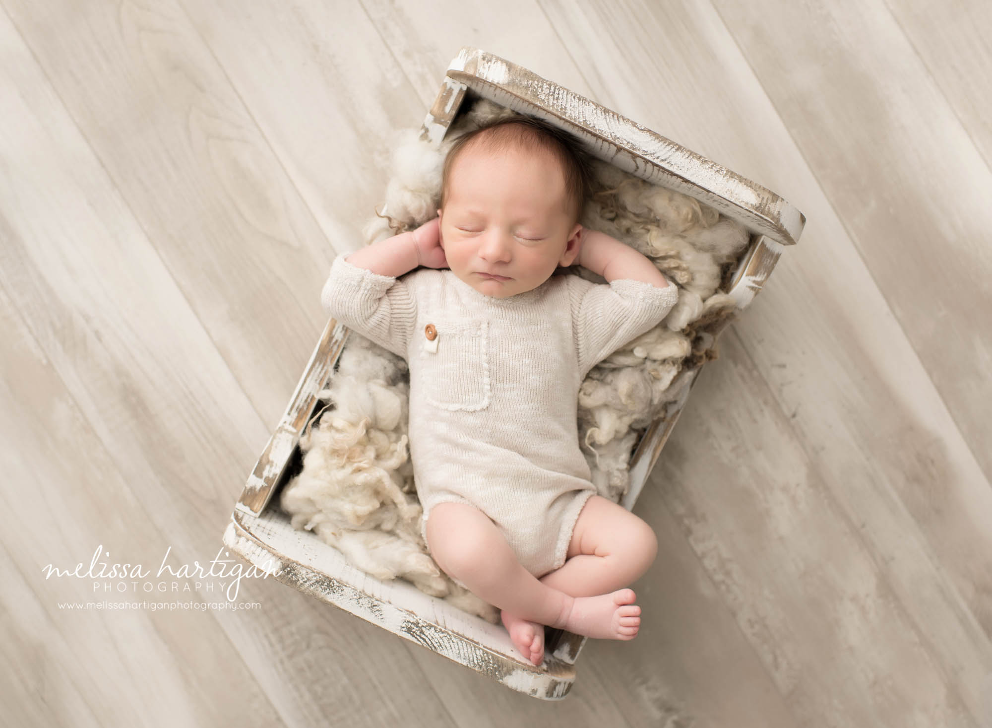 Newborn Photographer Connecticut newborn pose baby sleeping in wooden white bed 